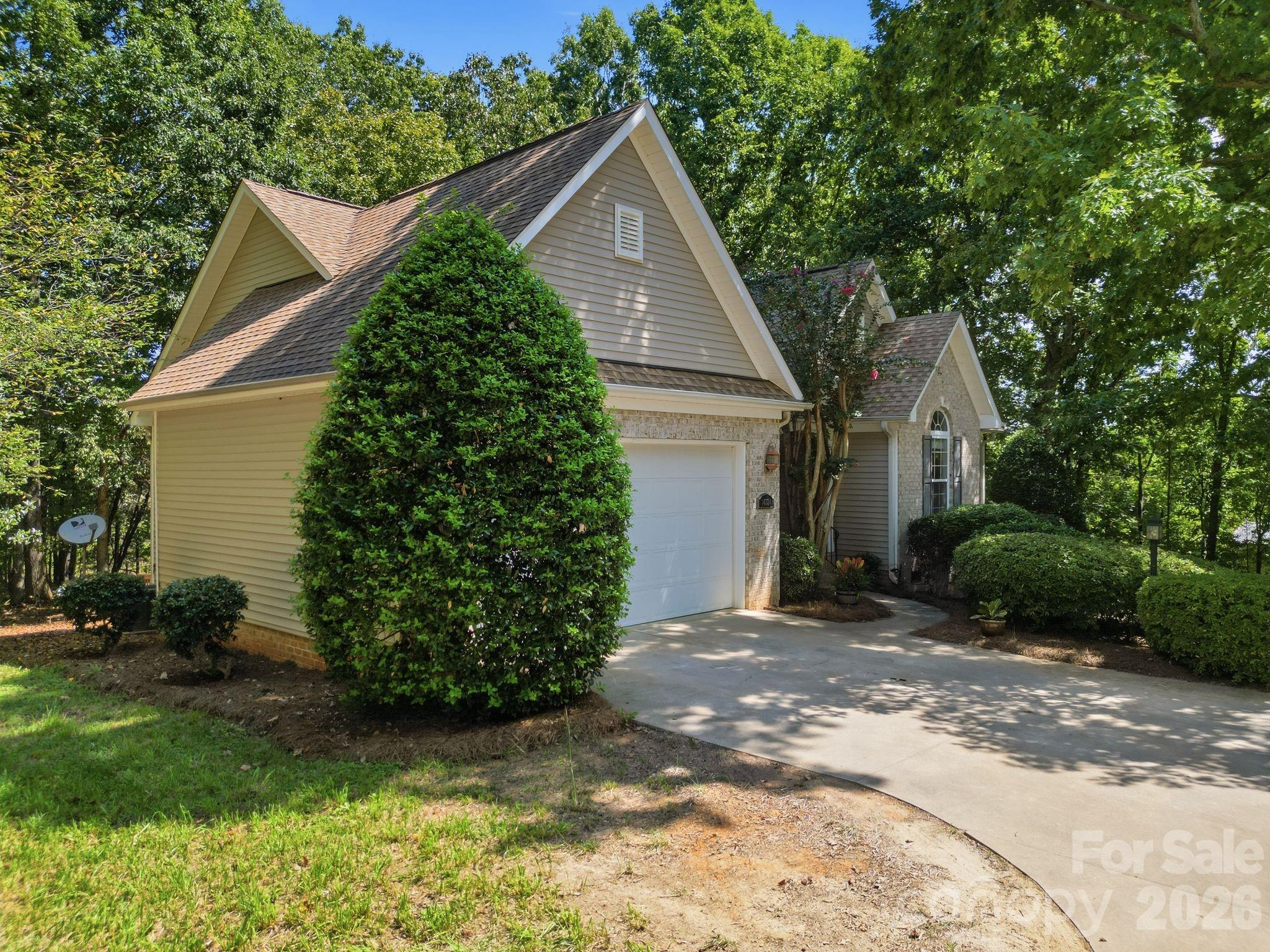 Professional landscape with a large, private wooded lot featuring mature trees. - 14724 Beatties Ford Road, Huntersville