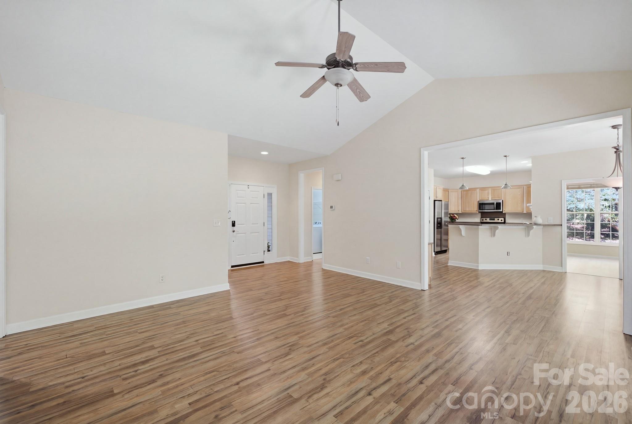 Living room with an open floor plan view leading into the kitchen. - 14724 Beatties Ford Road, Huntersville