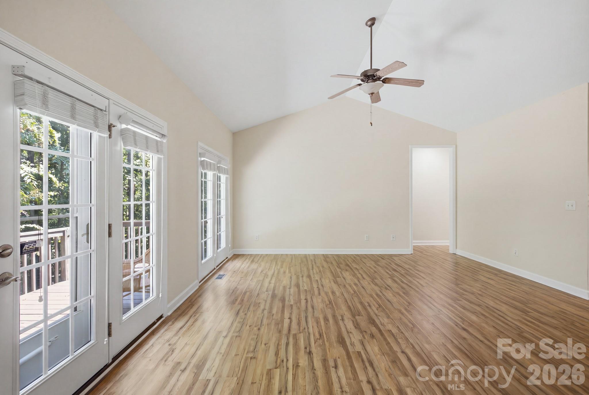 Spacious living room featuring elegant French doors that fill the space with natural light. - 14724 Beatties Ford Road, Huntersville