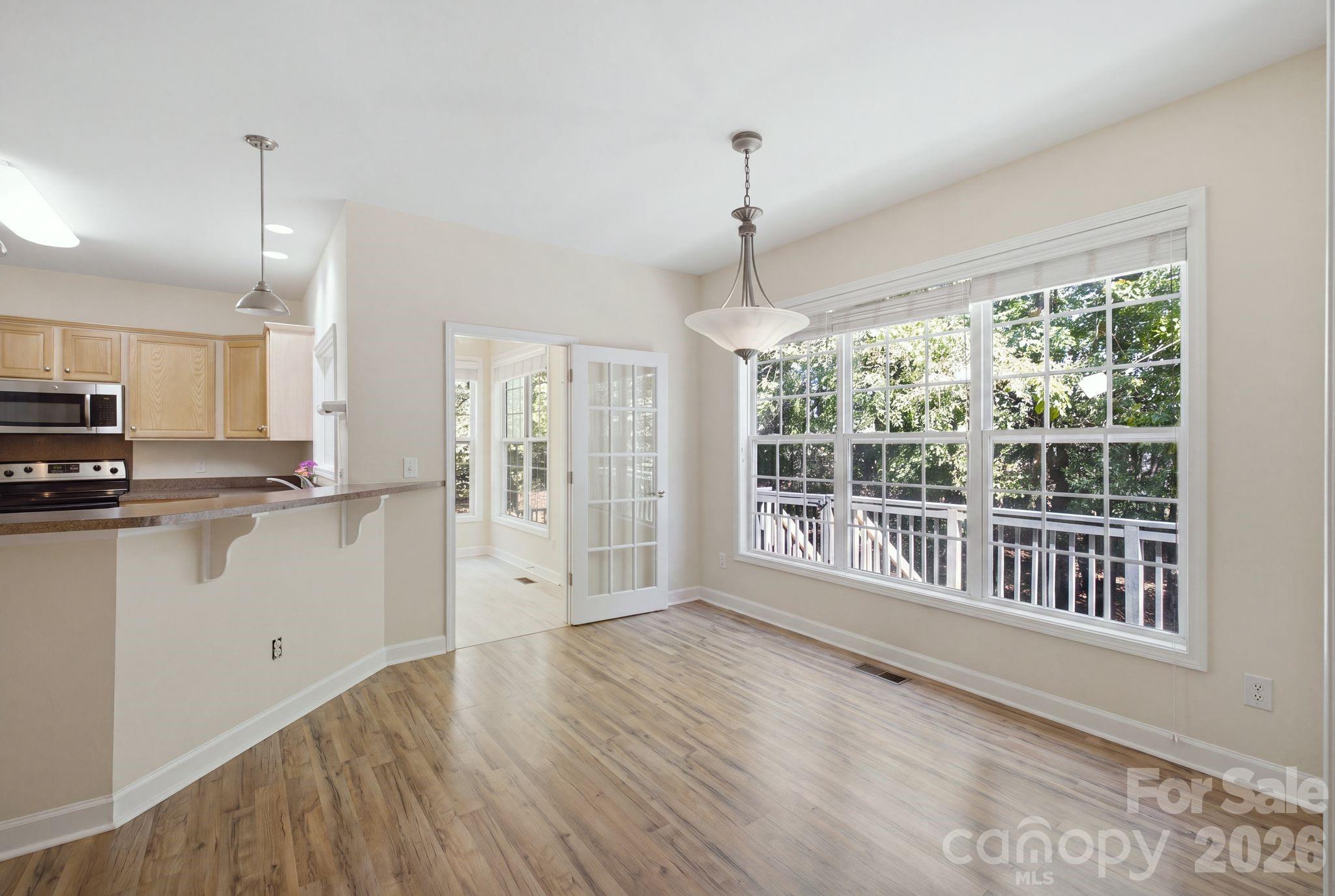 Stunning open-concept kitchen featuring modern appliances, premium cabinetry, and a spacious dining area perfect for entertaining. - 14724 Beatties Ford Road, Huntersville