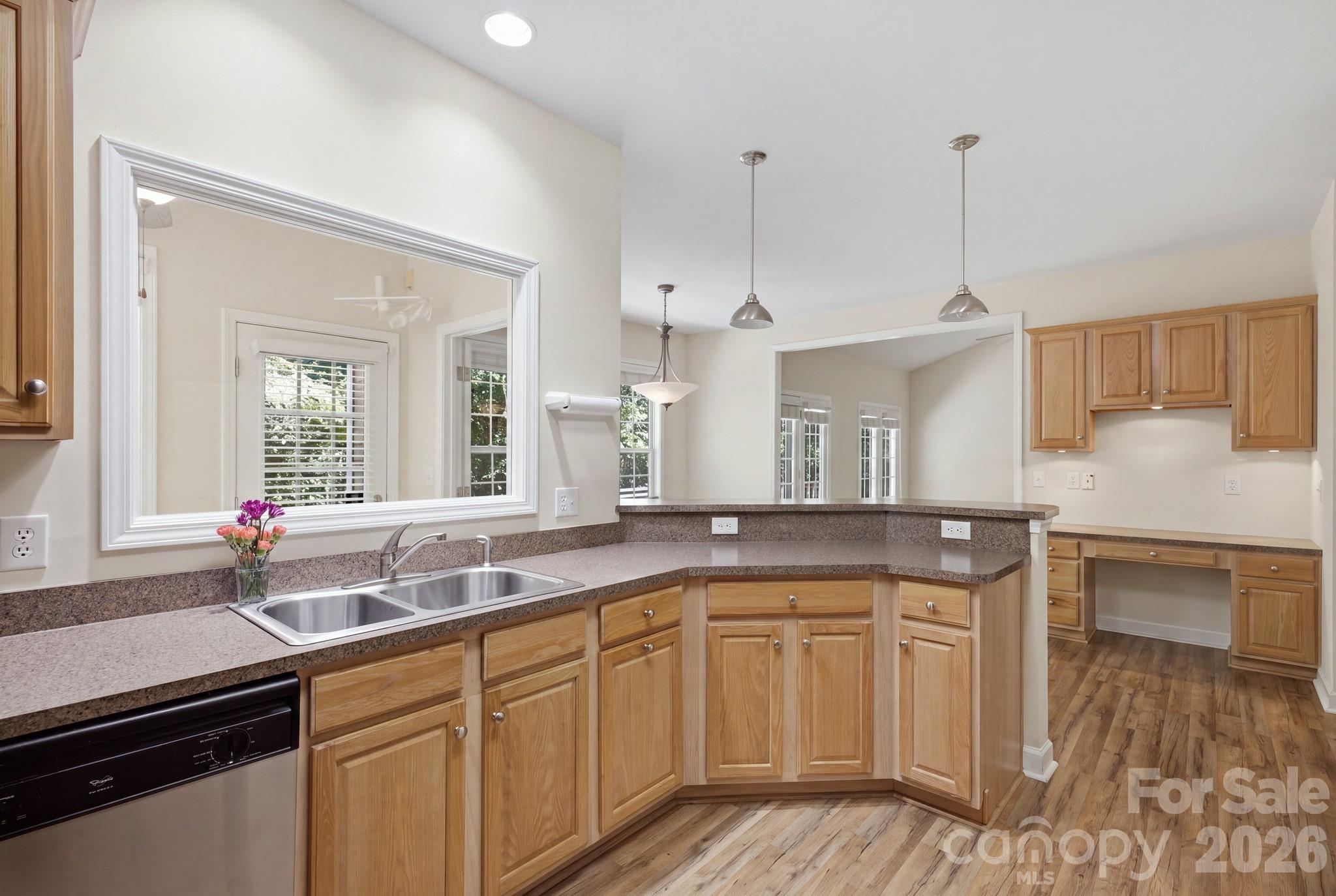 Kitchen, desk area, and breakfast bar looking into the living room. - 14724 Beatties Ford Road, Huntersville