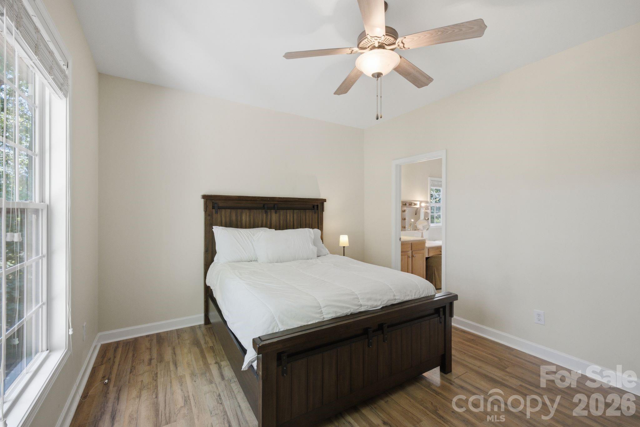 Primary bedroom suite with walk-in closet, dual vanities, and soaking tub. - 14724 Beatties Ford Road, Huntersville