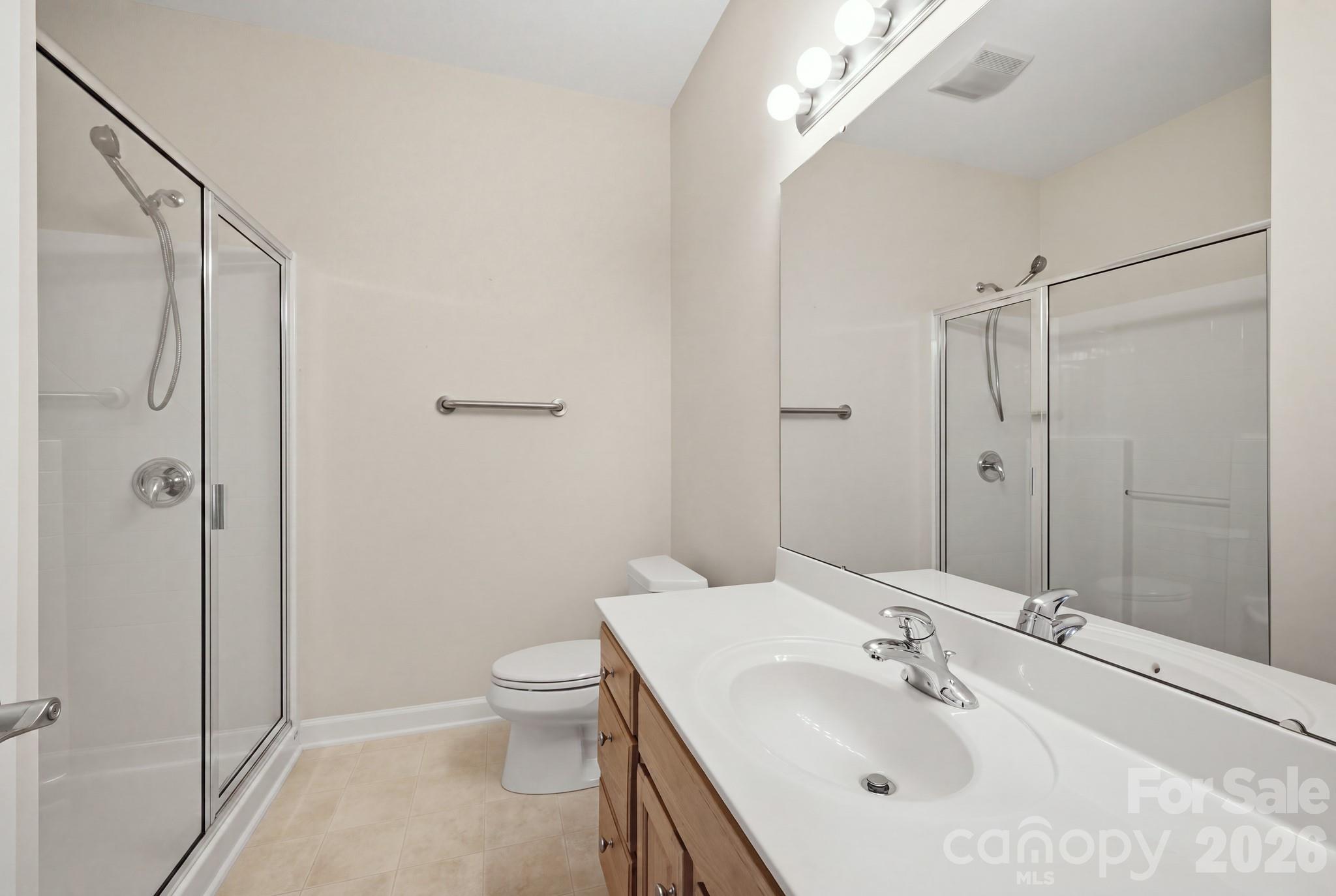 This photo shows the second bathroom, which features a convenient walk-in shower. - 14724 Beatties Ford Road, Huntersville