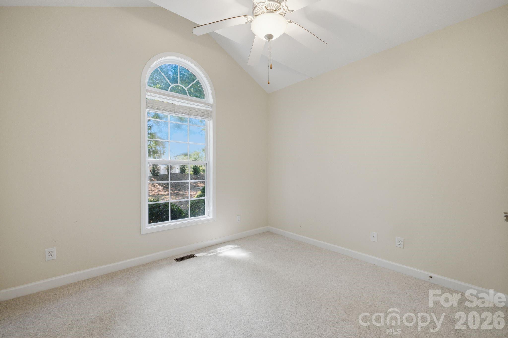 Spacious, sunlit third bedroom with plush carpet and ample closet space. Perfect for a guest room, office, or nursery. - 14724 Beatties Ford Road, Huntersville
