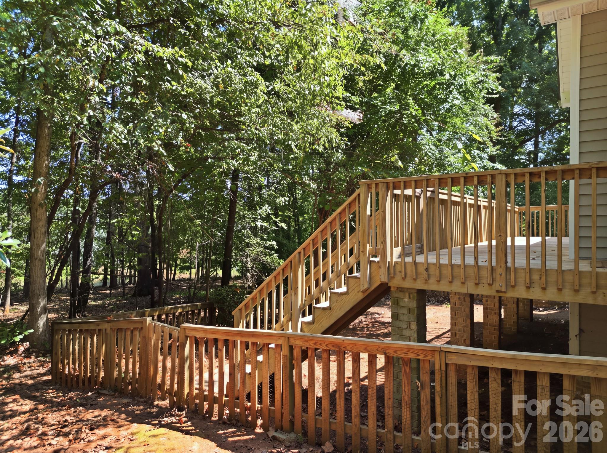 Back deck, stairs leading to small fenced yard - 14724 Beatties Ford Road, Huntersville