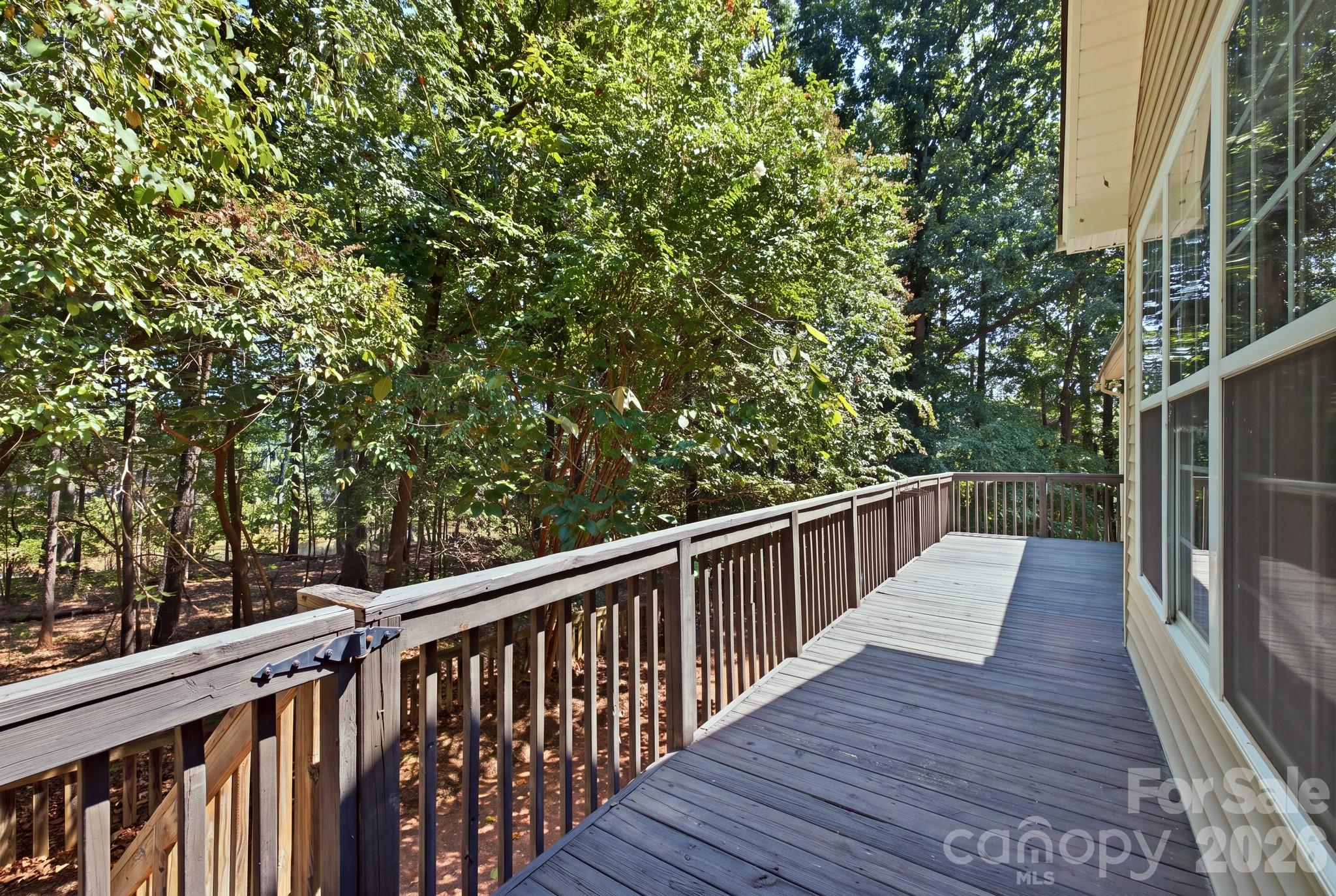 This image showcases the home's secluded rear deck, which offers a perfect setting for unwinding. - 14724 Beatties Ford Road, Huntersville