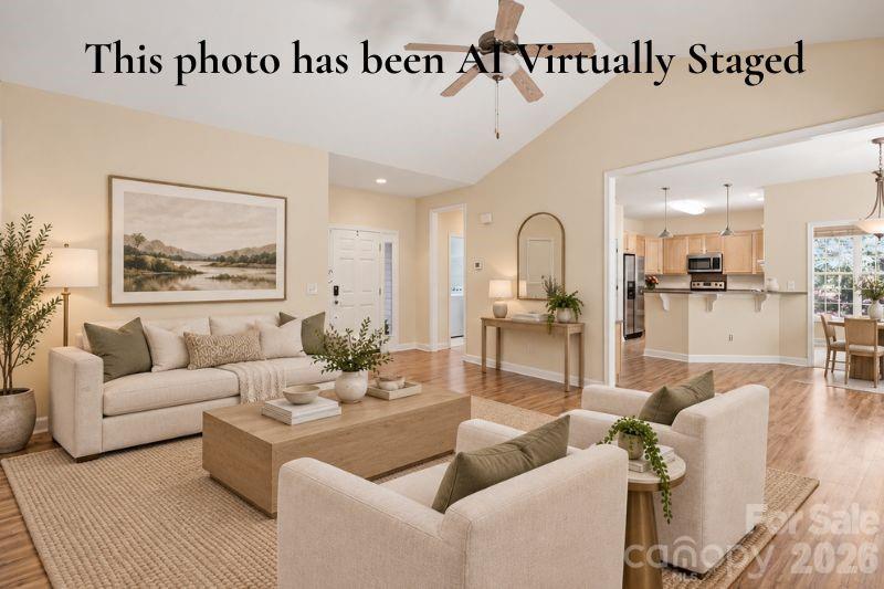 Virtually Staged Living room with virtual staging that shows the view into the kitchen. - 14724 Beatties Ford Road, Huntersville