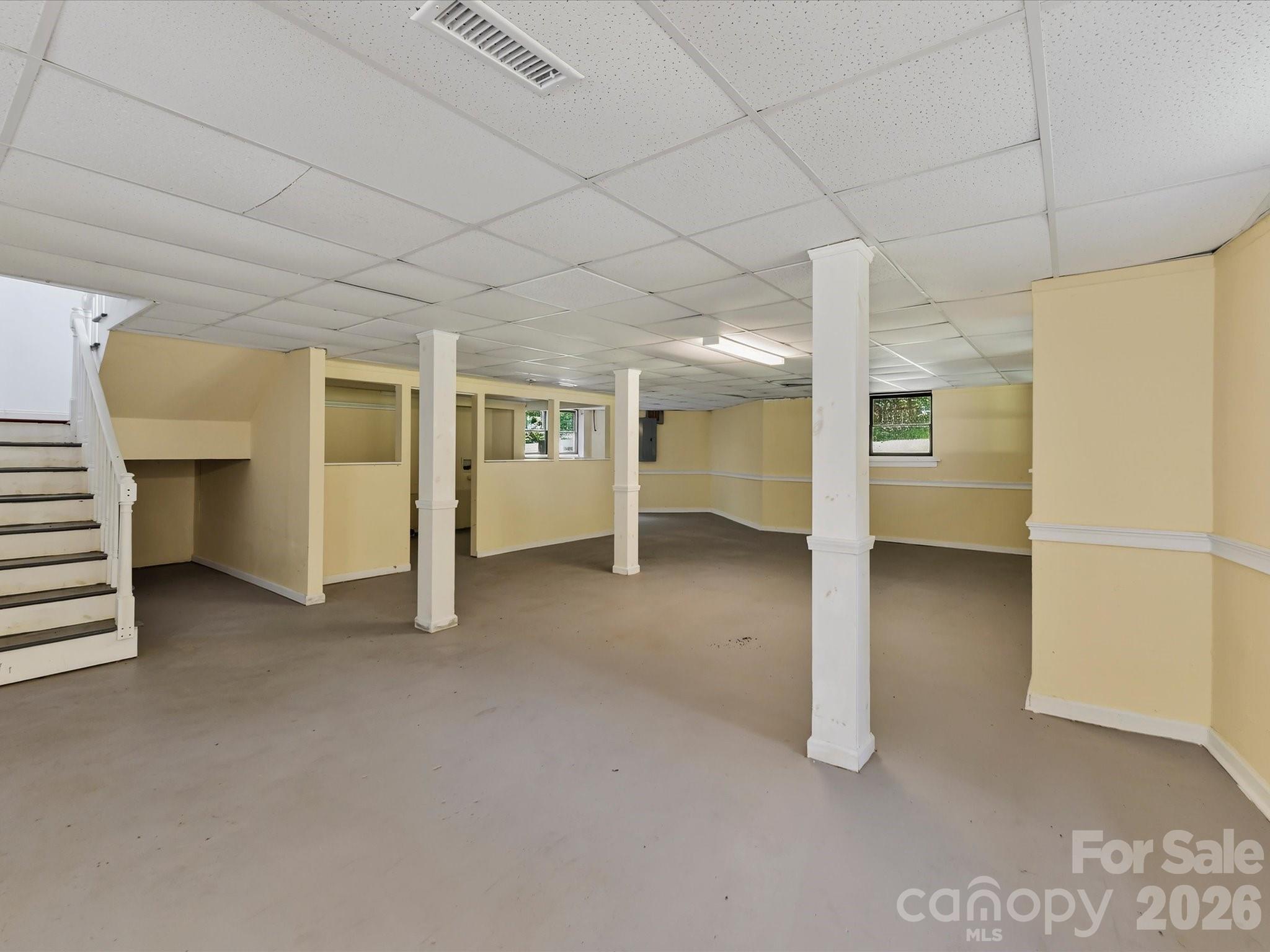 Expansive finished lower level offers flexible bonus space with endless possibilities for a recreation room, home gym, media room, workshop, or additional living area. - 9821 Harvest Lane, Davidson