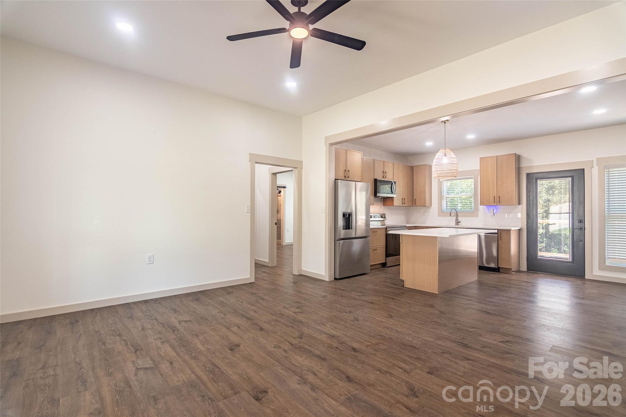 Walking into the living room from the front door you immediately see the lovely floors and open spaces! Door on right goes out to the rear wooden deck. - 98 Lexxi Lane, Tryon