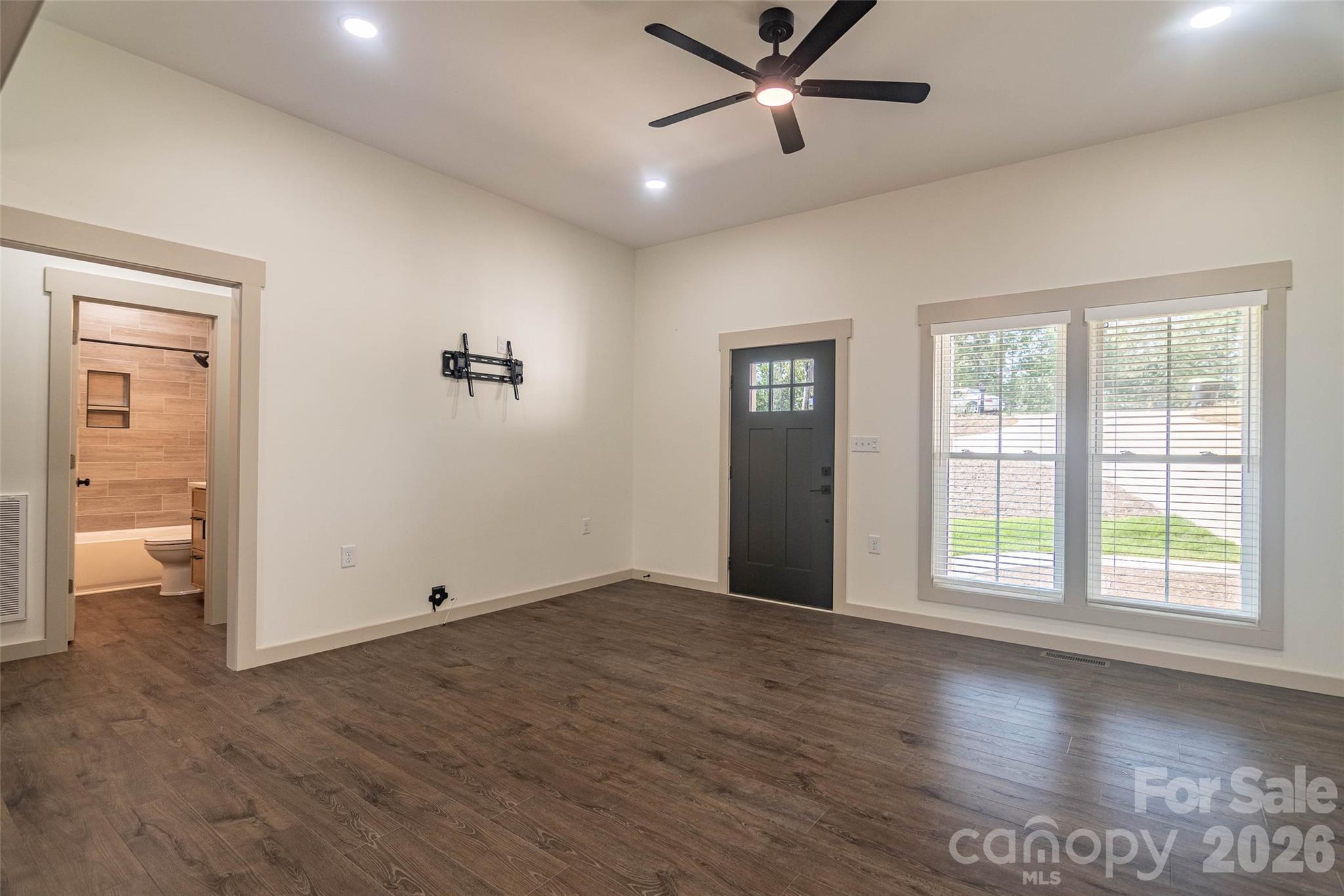 Looking back to the living room from the kitchen. Light and bright.! Door on left goes to the second bathroom and second and third bedrooms. - 98 Lexxi Lane, Tryon
