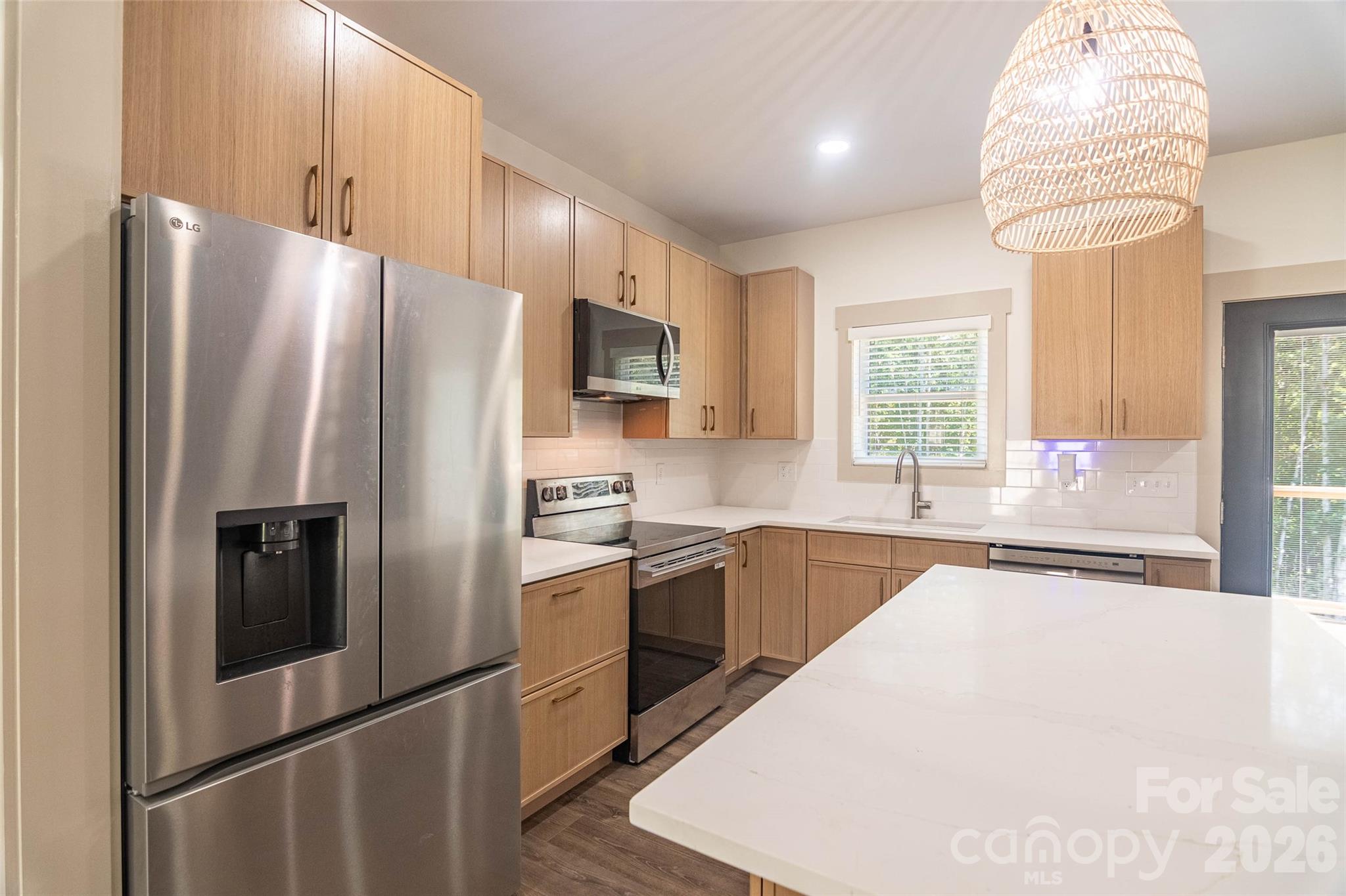 The kitchen is well appointed with Stainless Steel Appliances and lots of natural light! - 98 Lexxi Lane, Tryon