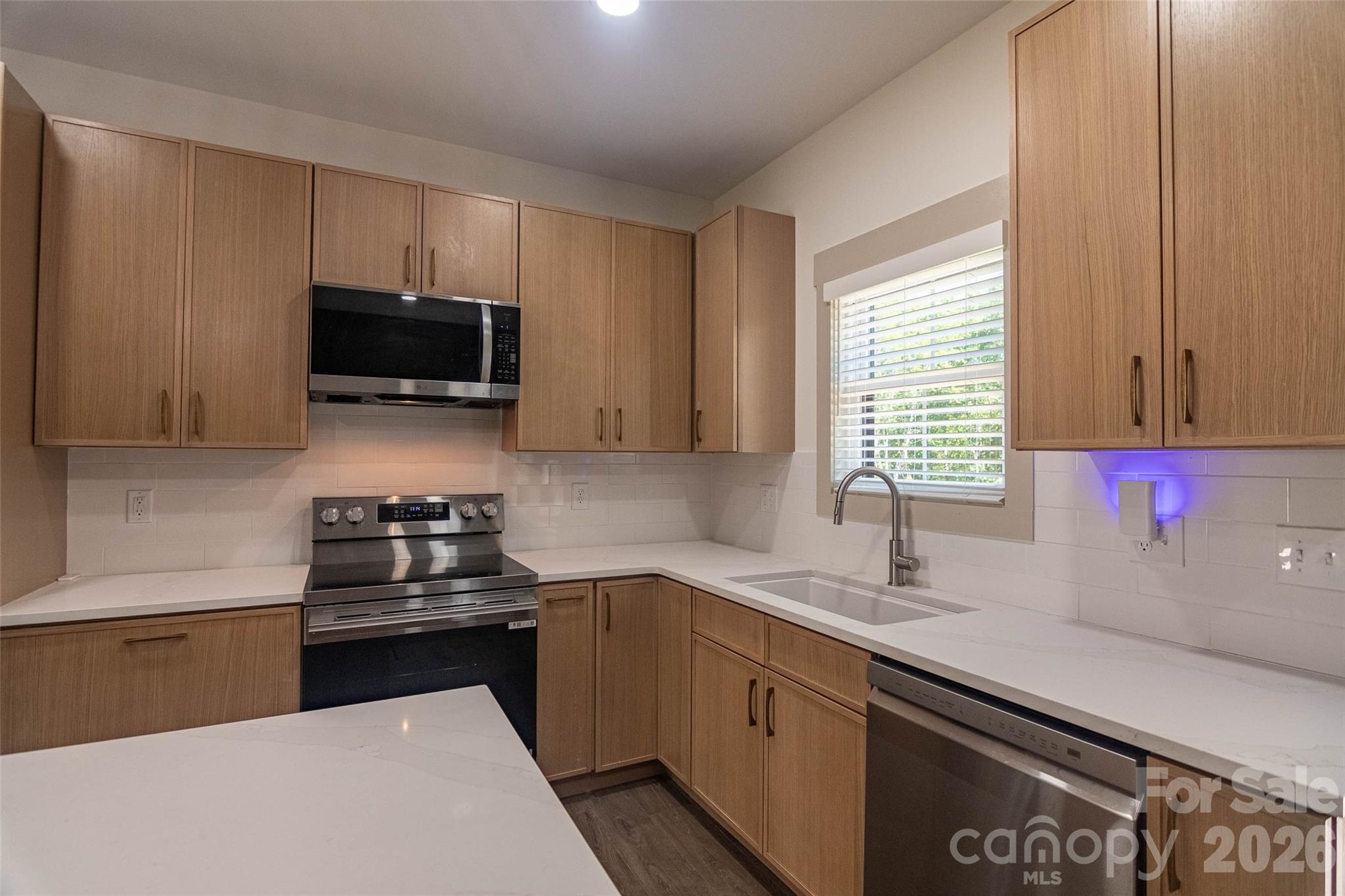 Lots of cabinets and counter space, as well as the handy breakfast bar / island in the middle of the kitchen! - 98 Lexxi Lane, Tryon