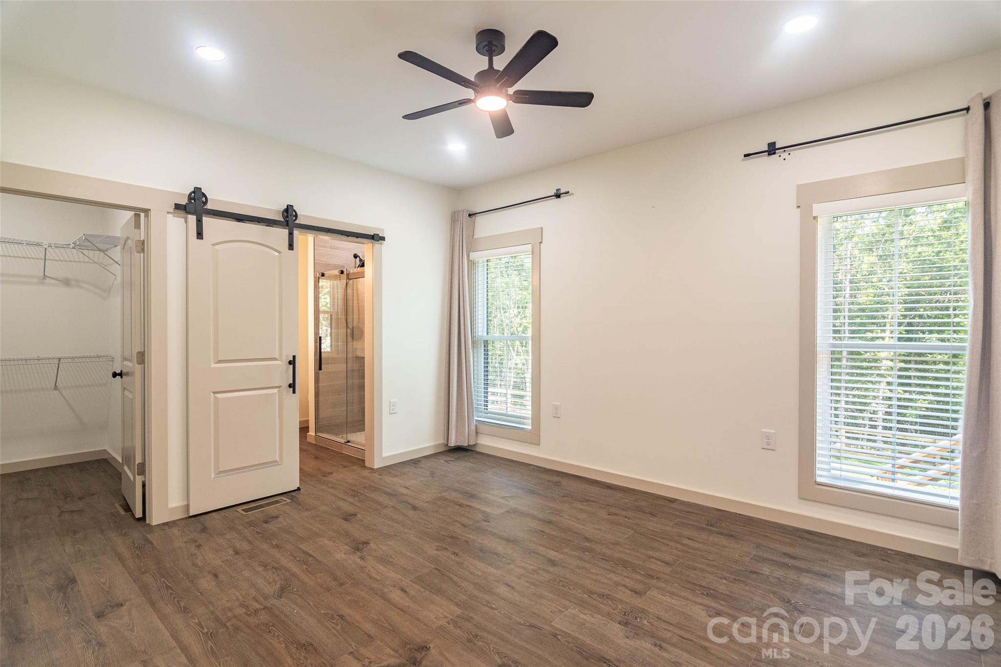 The primary bedroom suite has windows to the back yard and the tree line just beyond! Custom Window Blinds in each room! - 98 Lexxi Lane, Tryon
