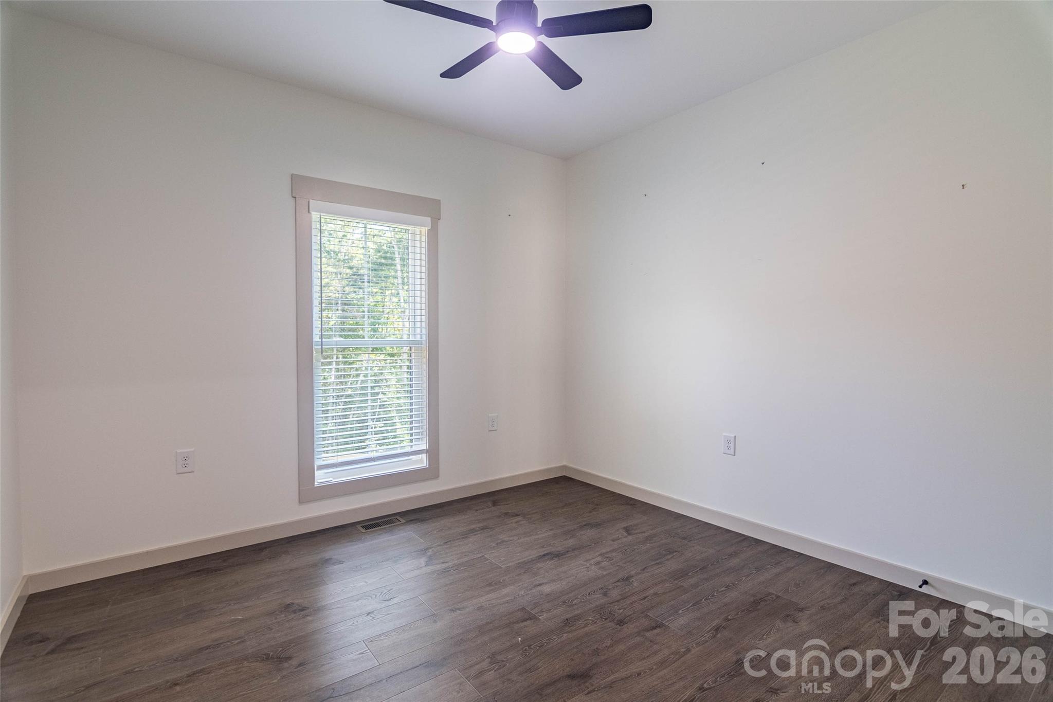 Second bedroom on the opposite side of the house from the primary. Same beautiful flooring and custom blinds! - 98 Lexxi Lane, Tryon