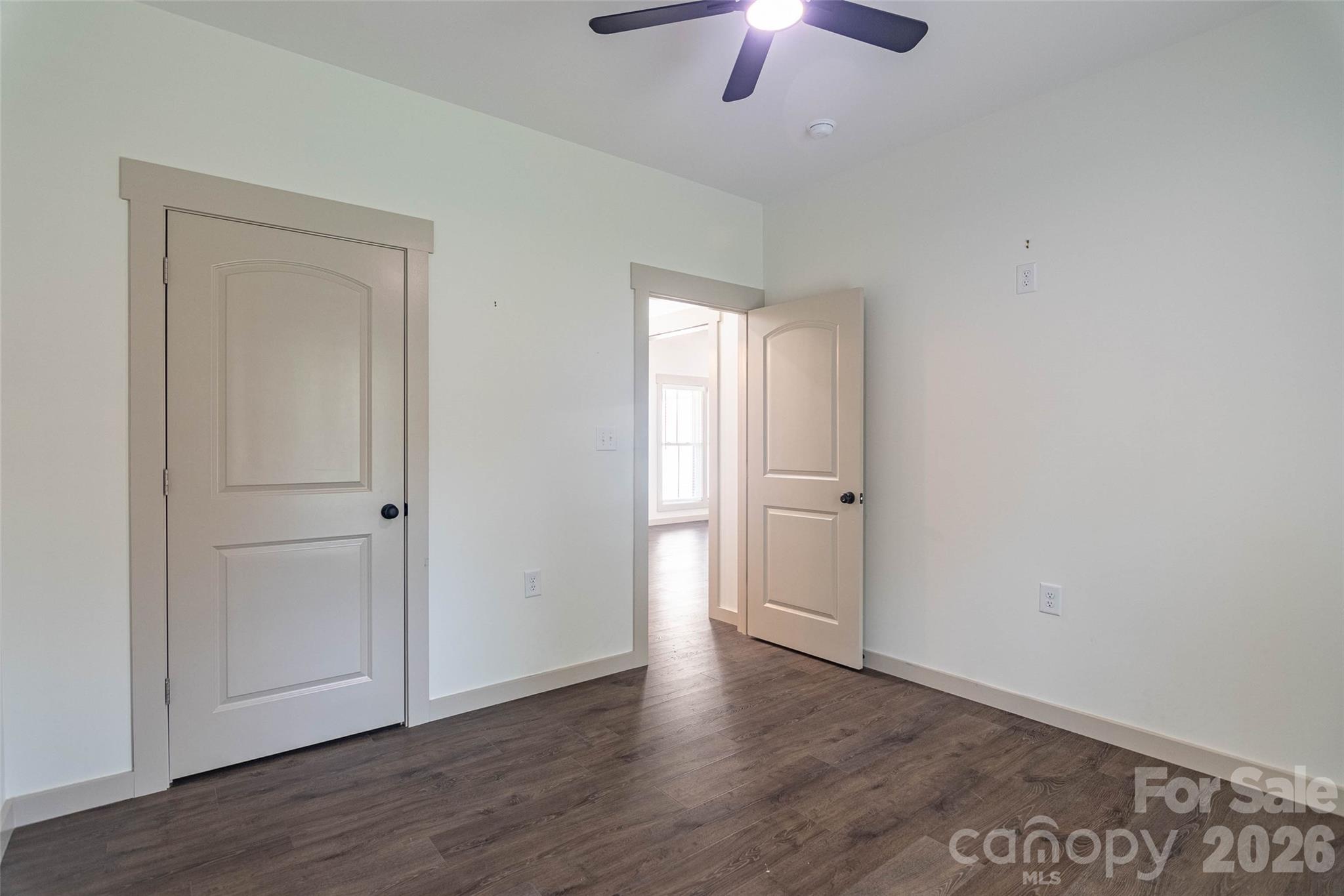 Second bedroom on the opposite side of the house from the primary. Same beautiful flooring! Good sized closet here! - 98 Lexxi Lane, Tryon