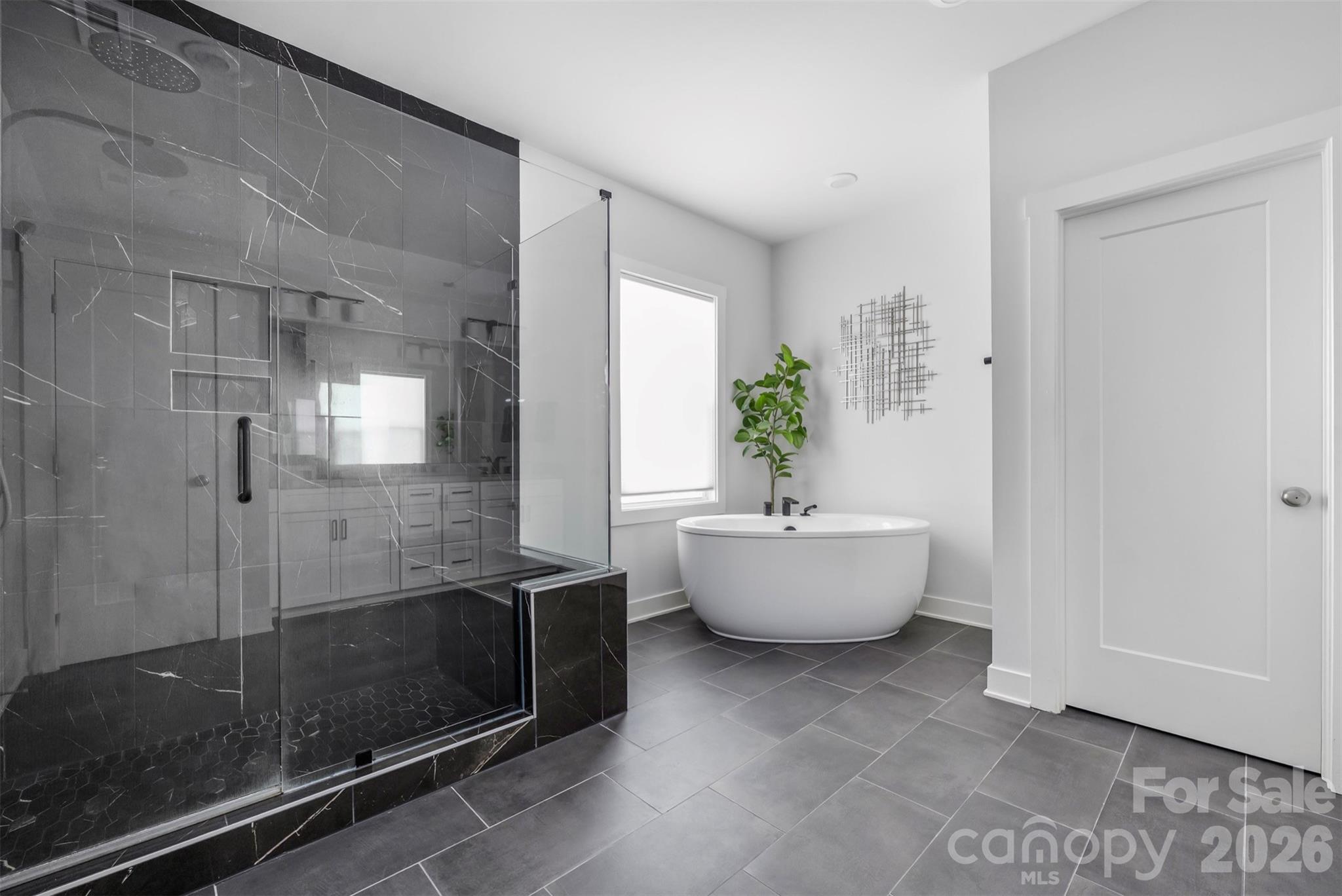 Primary bath with freestanding soaking tub and oversized black-tile shower - 4320 Tournette Drive, Indian Land