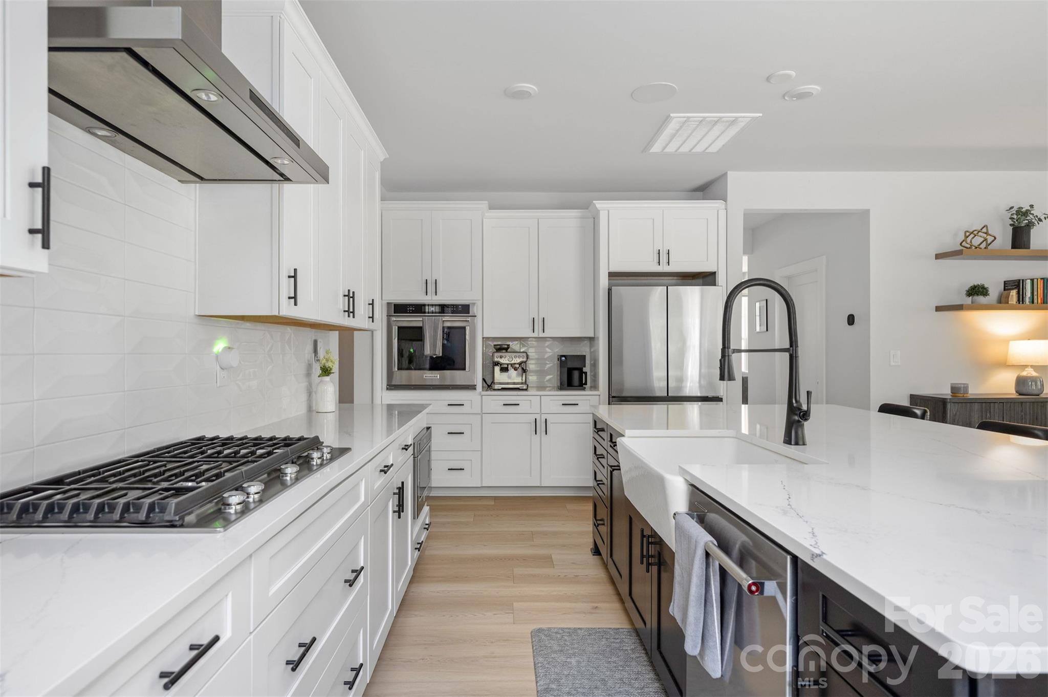 KitchenAid gas cooktop with canopy hood, wall oven, and microwave drawer - 4320 Tournette Drive, Indian Land