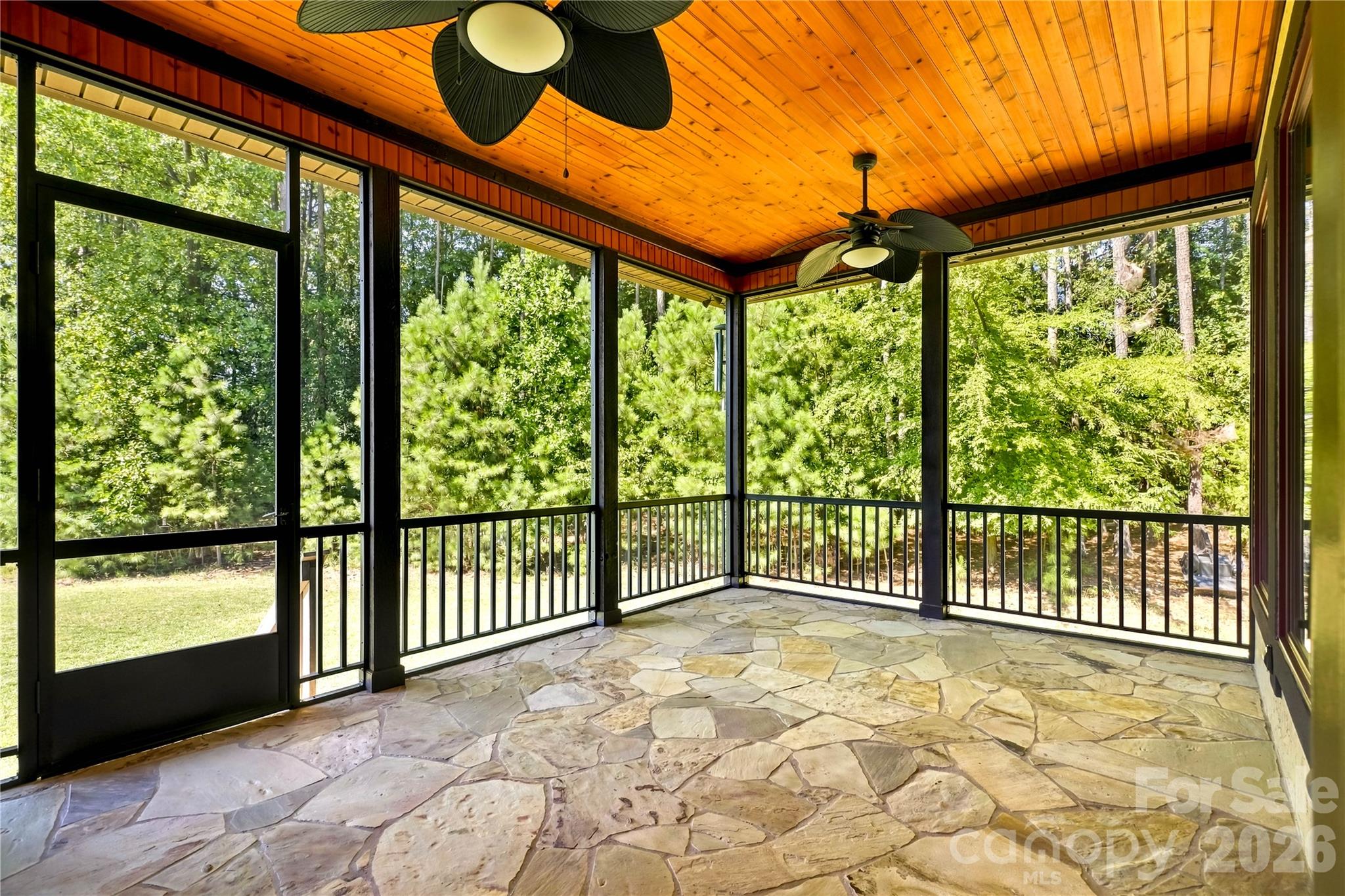 Wow - this screened in porch has lots of space to make your own with natural flagstone, dual ceiling fans and steps to backyard. - 108 Washam Road, Mooresville