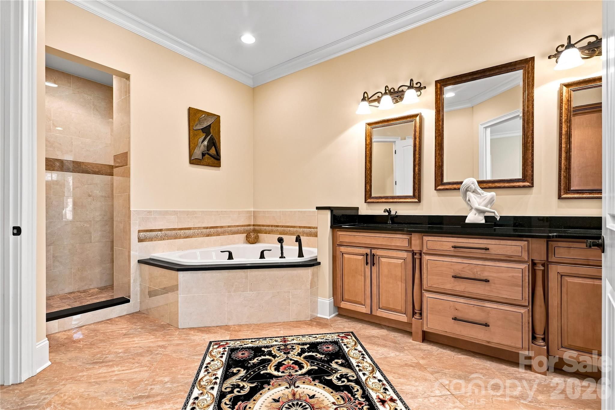 Primary ensuite with decorative medallion floor inlay and separate walk in closets - 108 Washam Road, Mooresville
