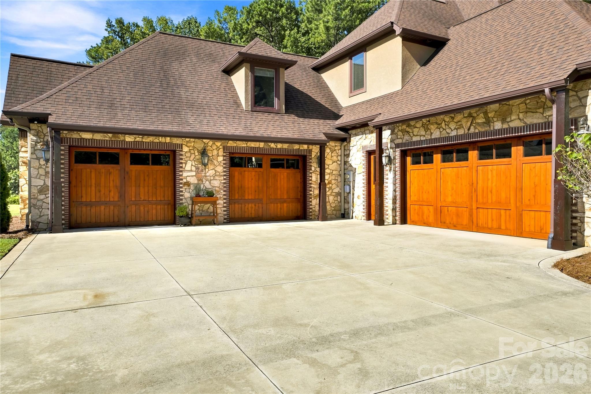 Oversized 4 stall wood insulated garage doors. - 108 Washam Road, Mooresville