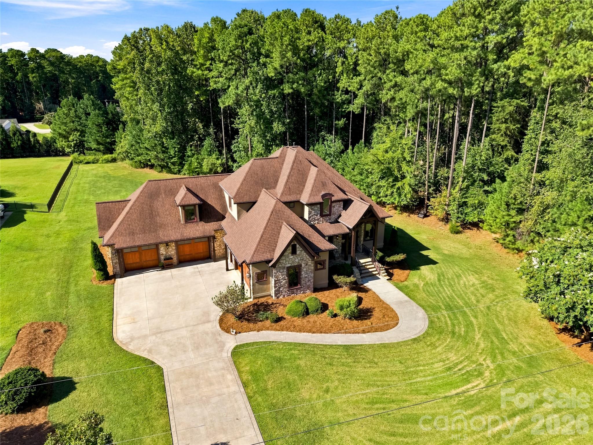 Exterior accent with cedar trim and hard coat stucco and stone. All with a 35 year shingle warranty too. - 108 Washam Road, Mooresville