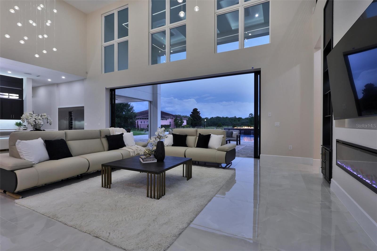 Two-story windows and expansive glass connect the interior with the outdoors - 1002 COYOTE CREEK WAY, REUNION
