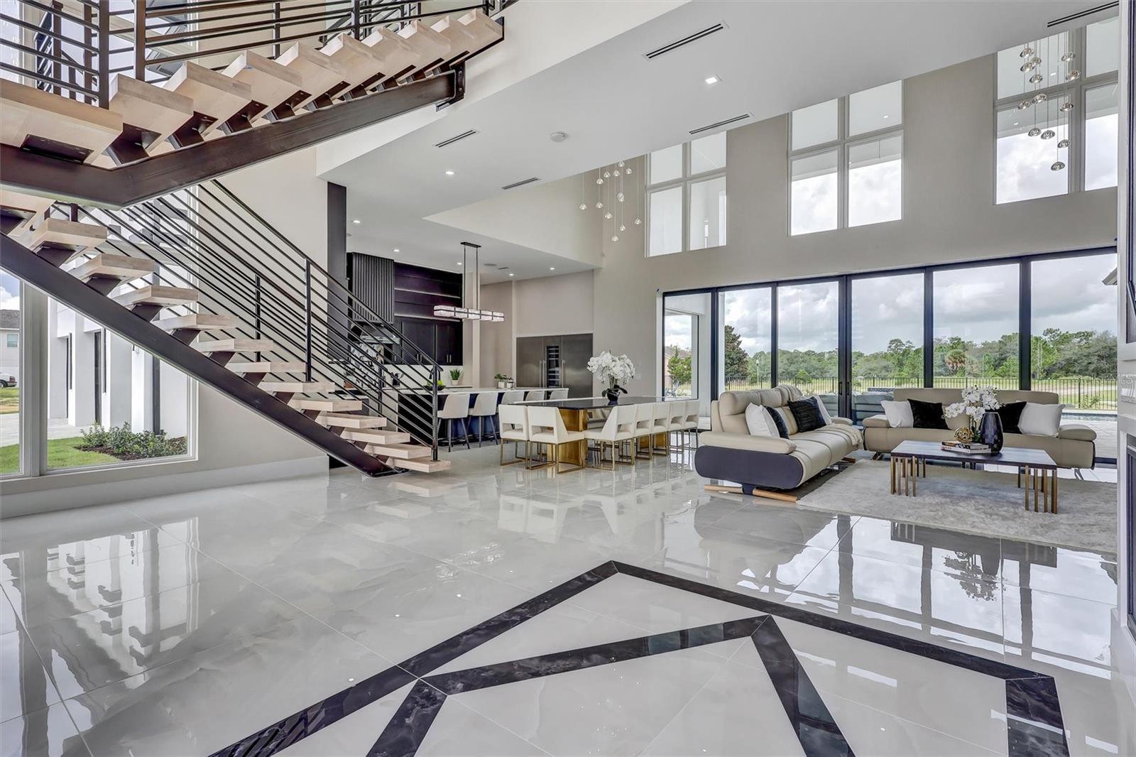 Dramatic open-concept living framed by the floating staircase and walls of glass - 1002 COYOTE CREEK WAY, REUNION