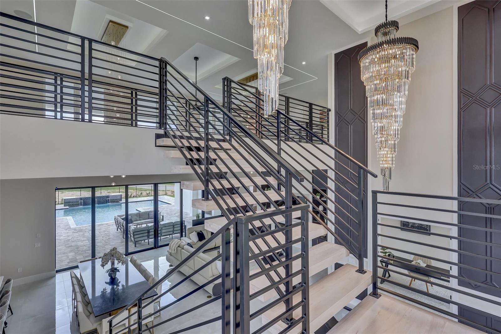 Architectural floating staircase creates a dramatic focal point between both levels - 1002 COYOTE CREEK WAY, REUNION