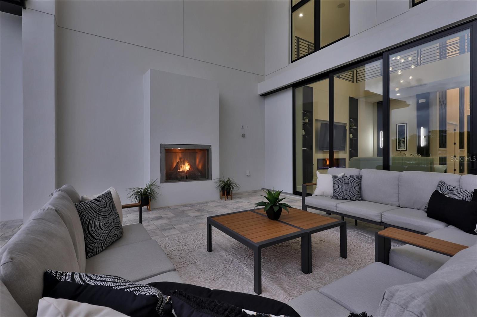 Private covered outdoor retreat with fireplace and direct access to the great room with pocketing sliders that hide behind the wall - 1002 COYOTE CREEK WAY, REUNION
