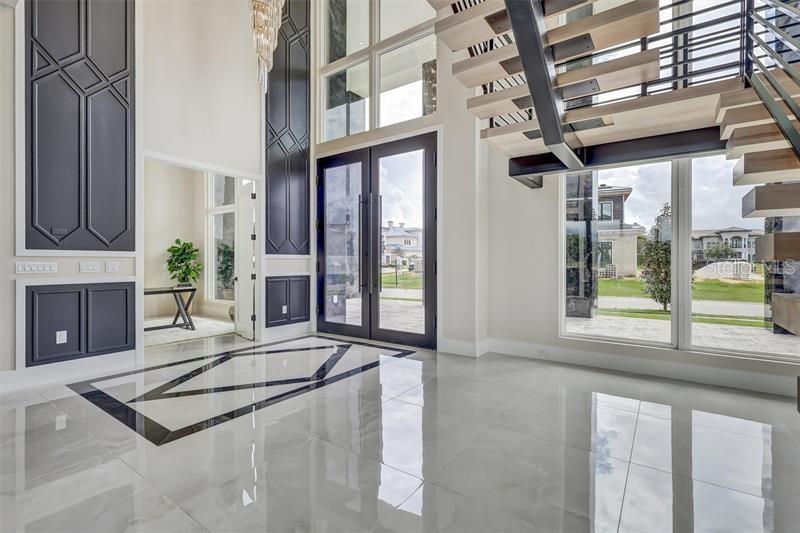 Dramatic entry framed by the floating staircase and two-story windows - 1002 COYOTE CREEK WAY, REUNION