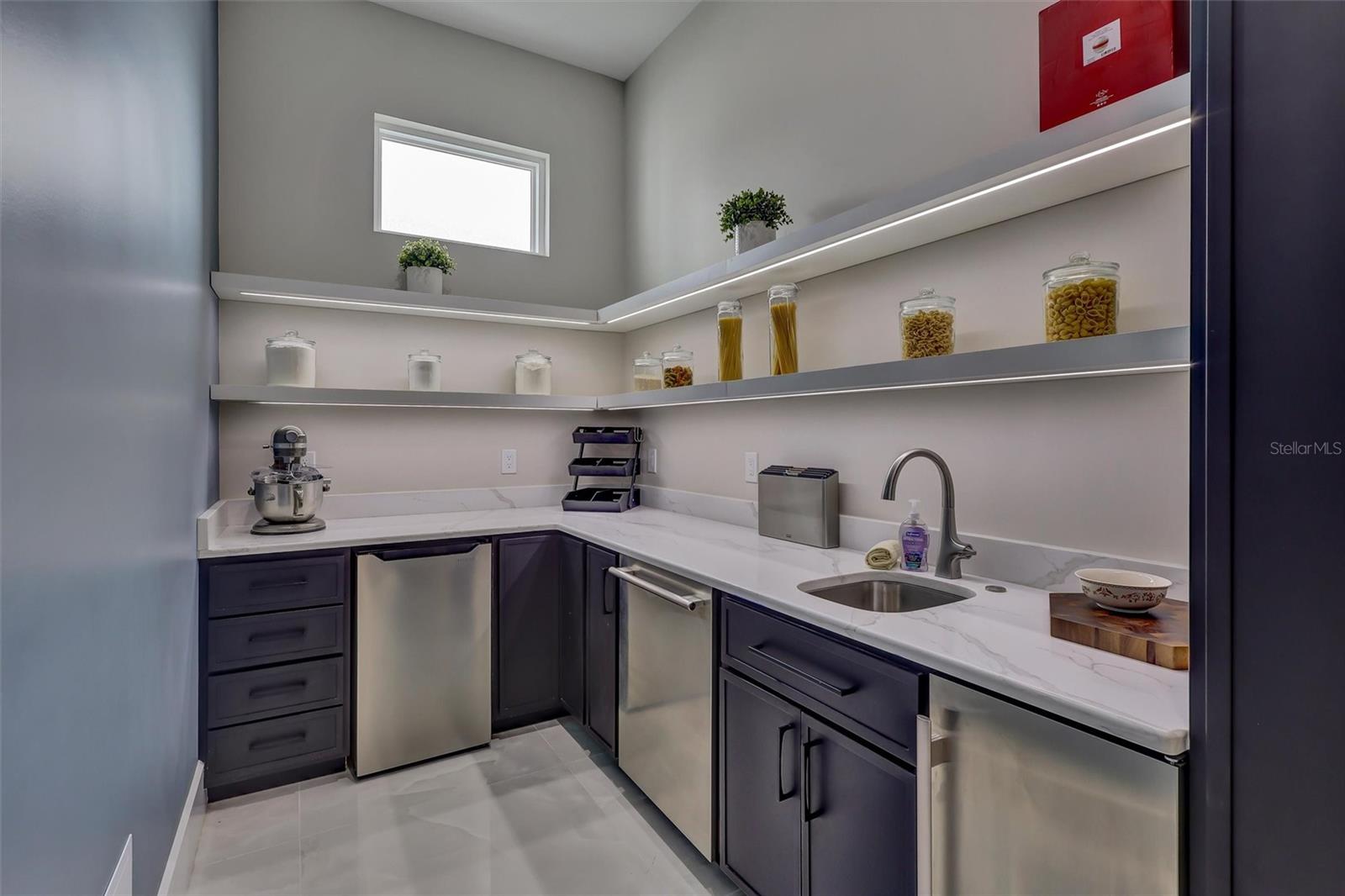 Scullery/Bulter's Pantry for prep and service space with cabinetry, sink and storage - 1002 COYOTE CREEK WAY, REUNION