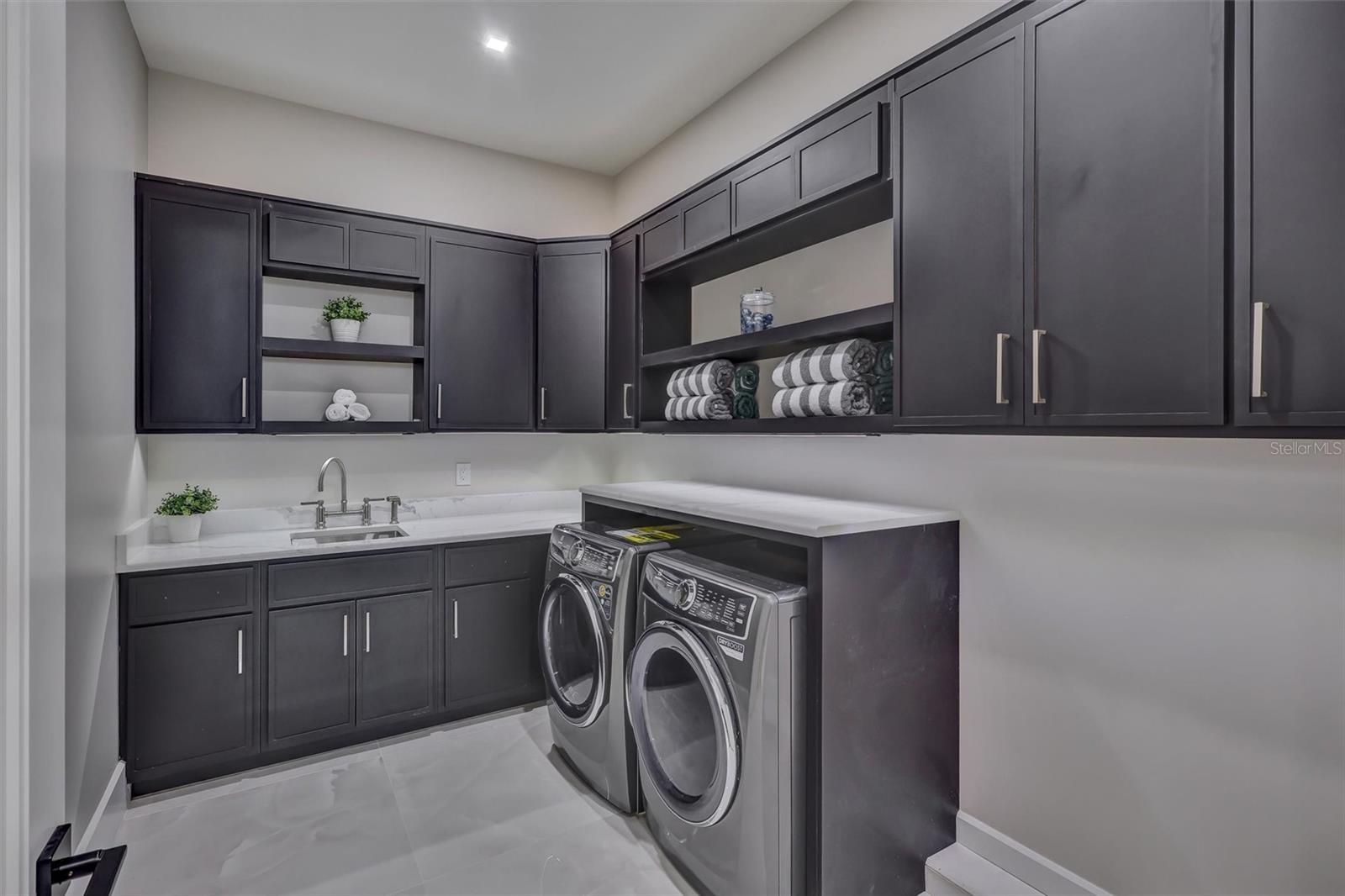 Large dedicated laundry room with extensive cabinetry, undermount lighting and workspace - 1002 COYOTE CREEK WAY, REUNION