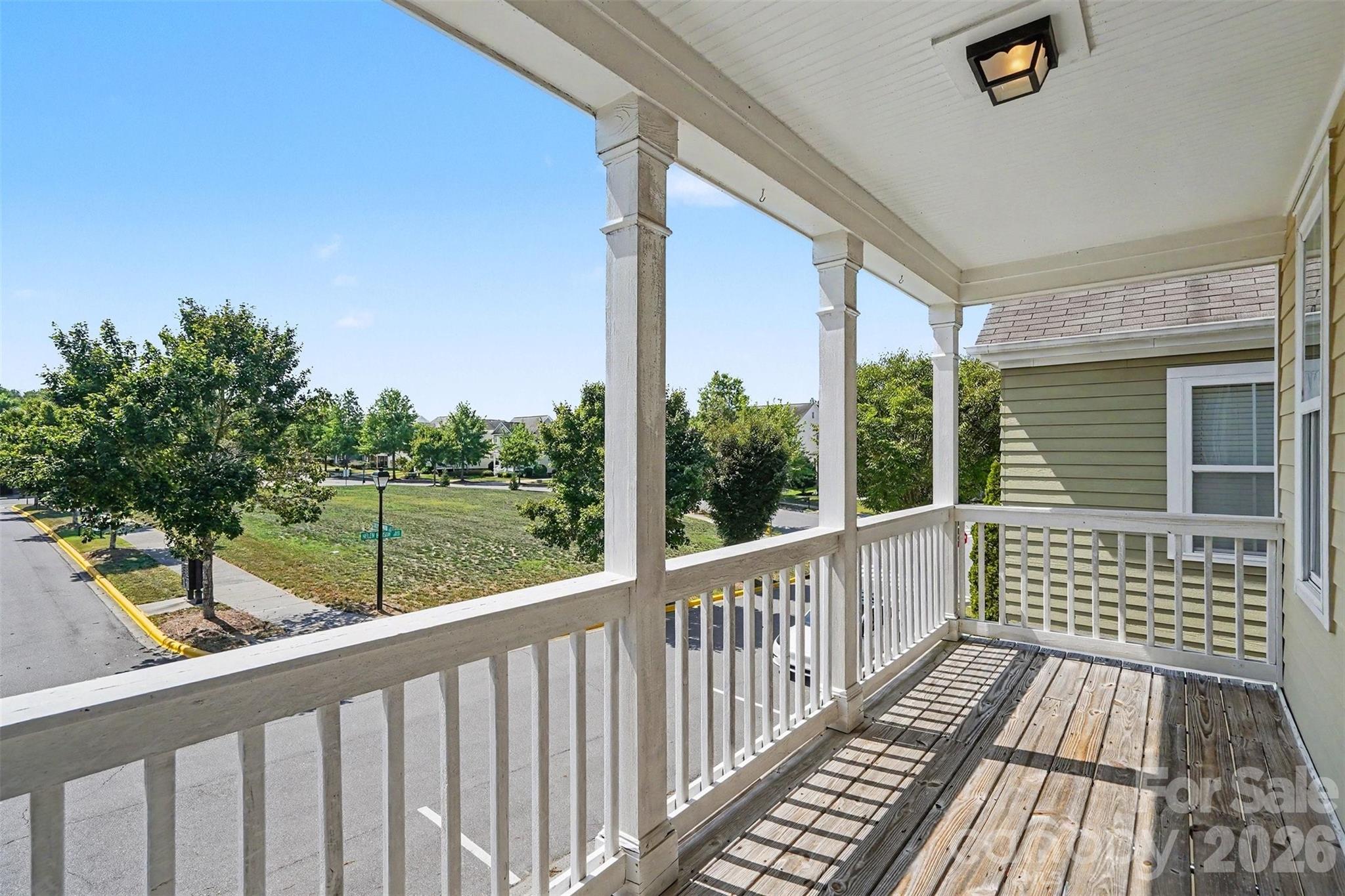 An upper covered front porch off the Primary overlooking a common area. - 13913 Helen Benson Boulevard, Davidson