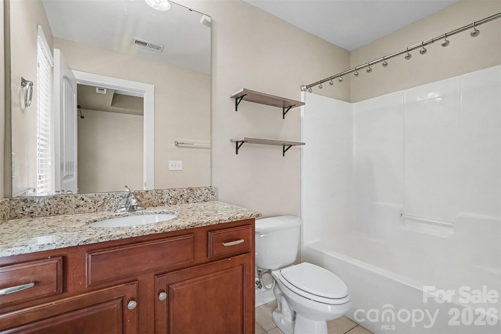Bathroom that adjoins both secondary bedrooms with granite countertops - 13913 Helen Benson Boulevard, Davidson