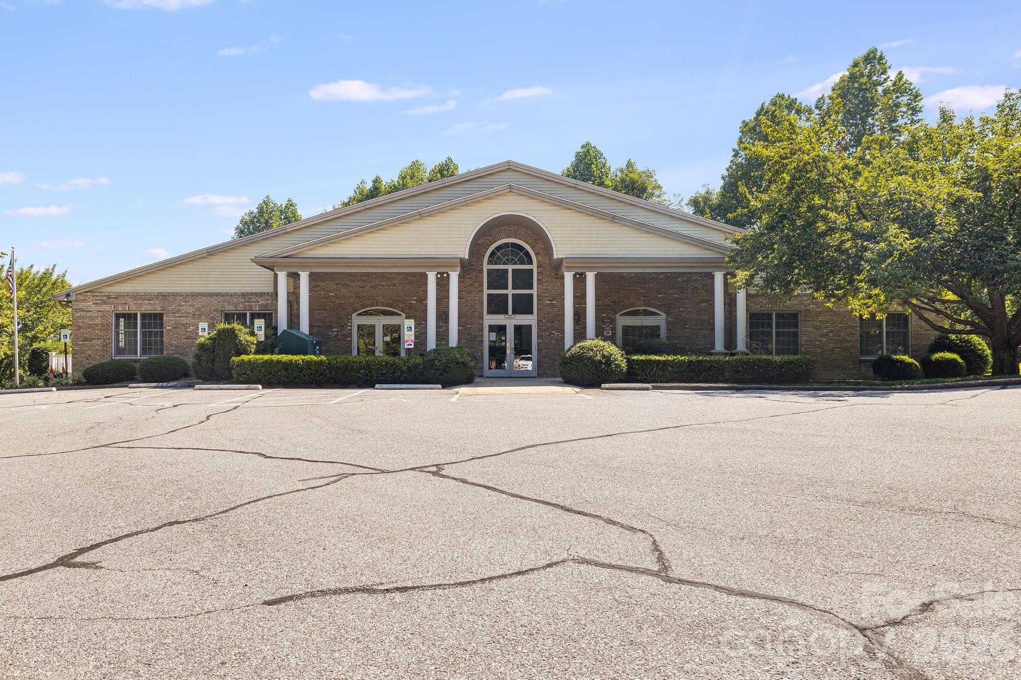 This is the neighborhood clubhouse that houses a large indoor swimming pool, a large meeting room with kitchen, and newly remodeled dressing rooms. Also, has a deck used for entertaining that have mountain views. - 212 Carriage Springs Way, Hendersonville