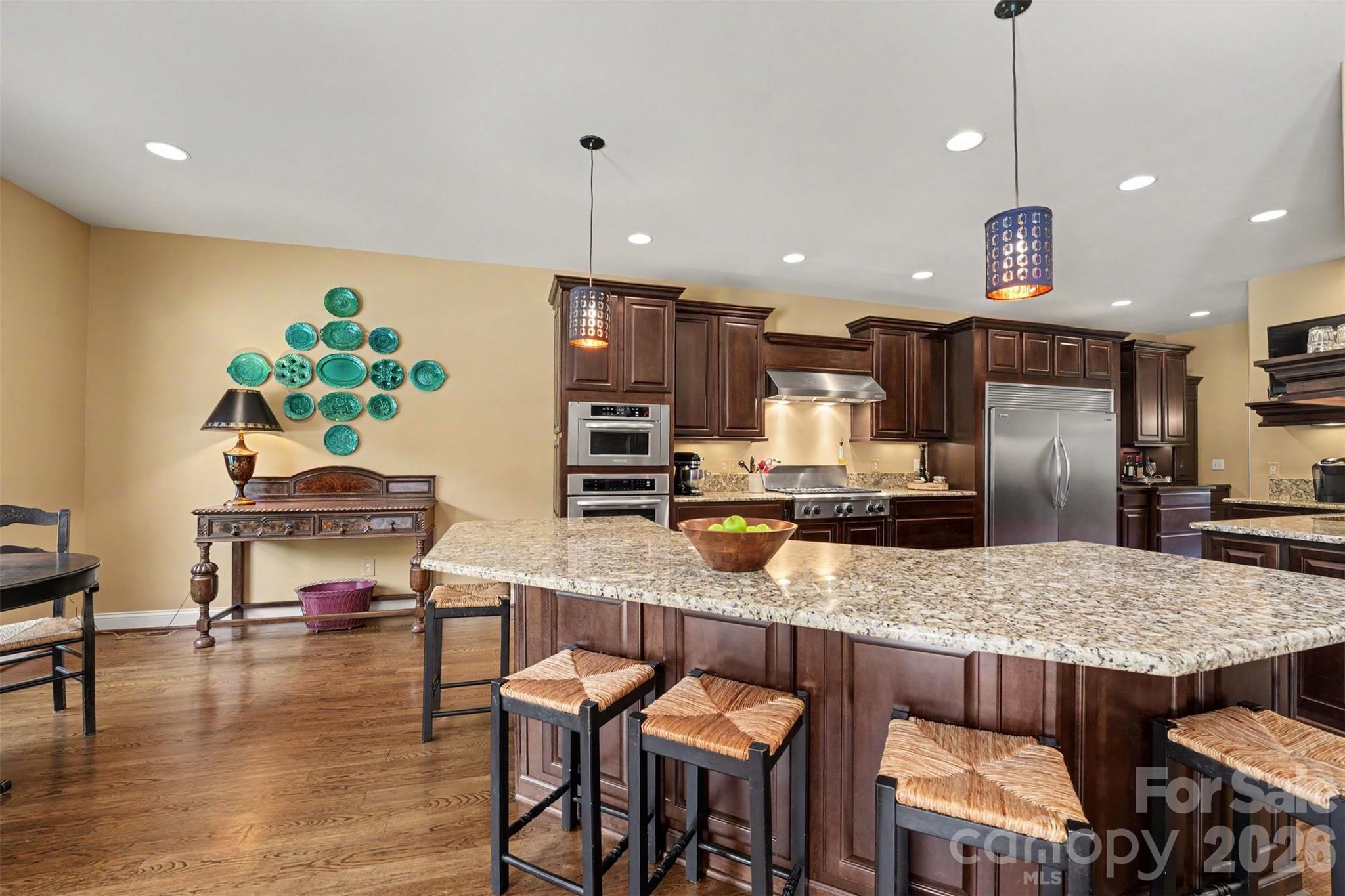 Kitchen with spacious area for a table along with island seating, check out the 6 burner stove with hood that is vented to the outside. - 120 Palos Verde Drive, Mooresville