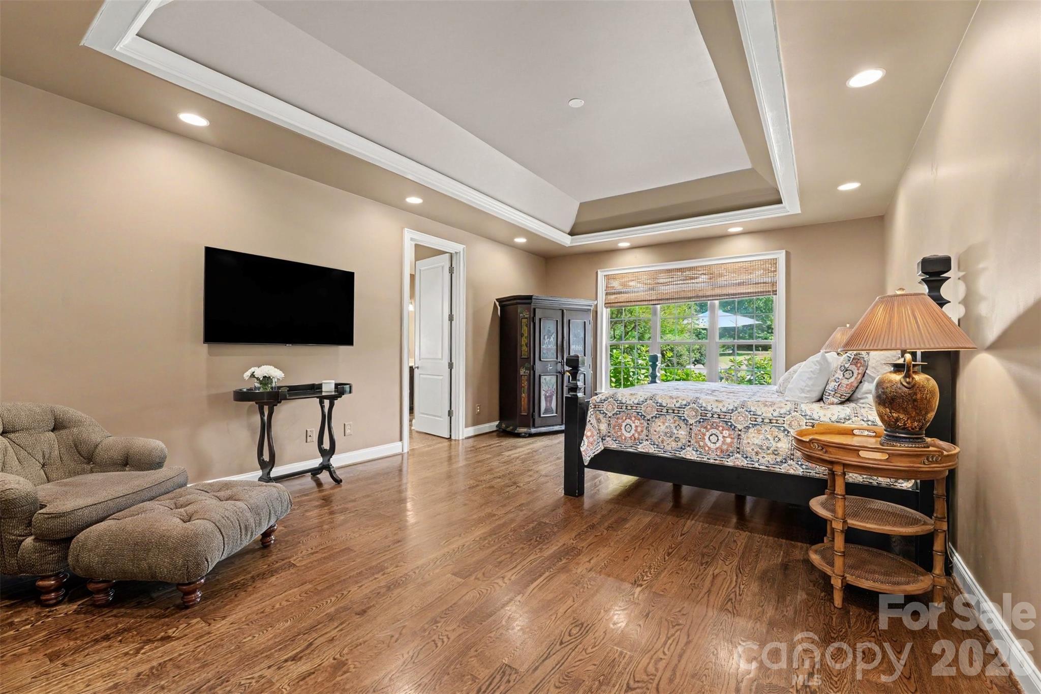 Main floor primary suite overlooking the back yard. Walk in closet with a closet system and plenty of space for a separate sitting area. - 120 Palos Verde Drive, Mooresville
