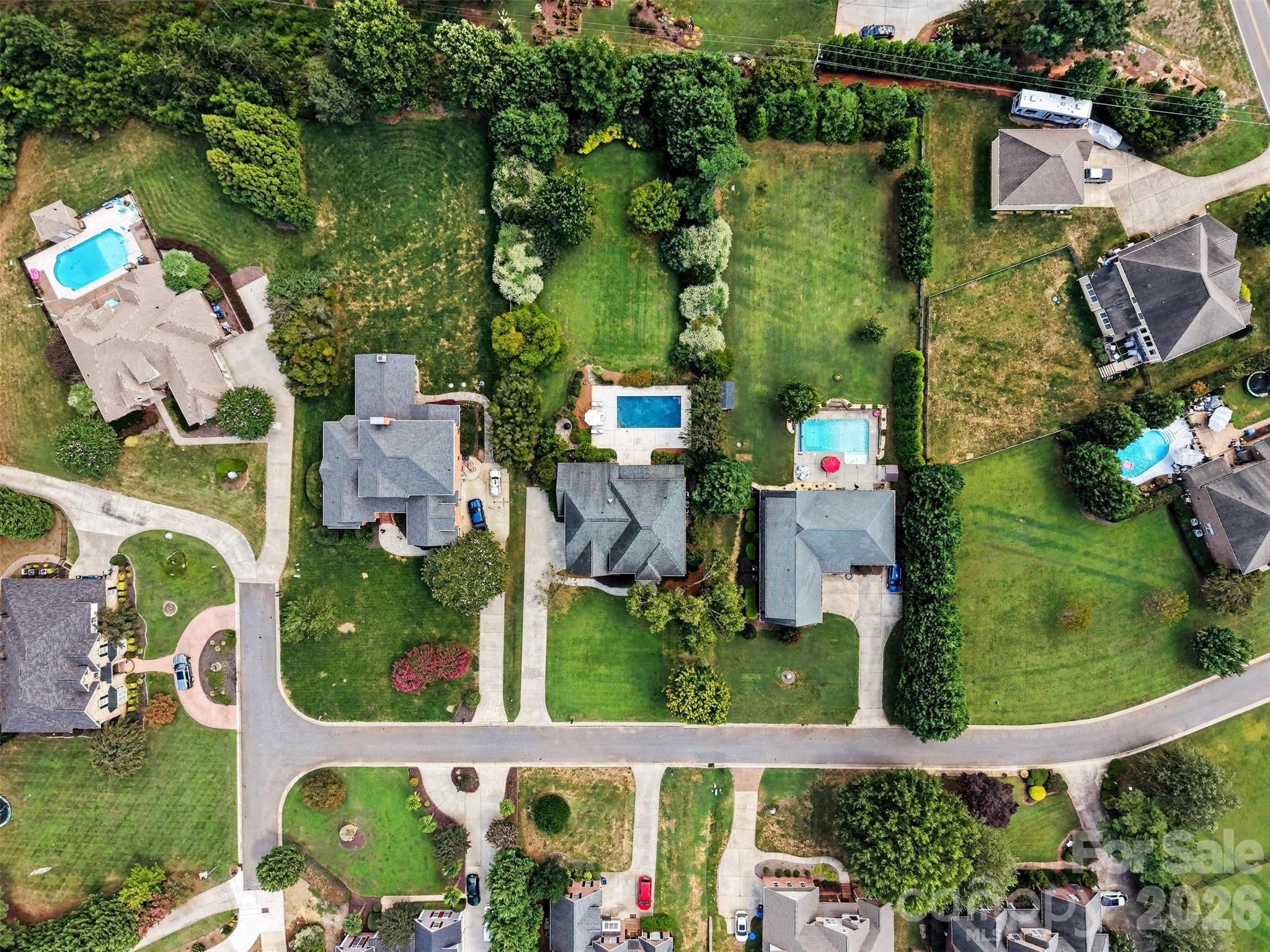 The mature landscaping around this backyard is perfect for privacy. - 120 Palos Verde Drive, Mooresville