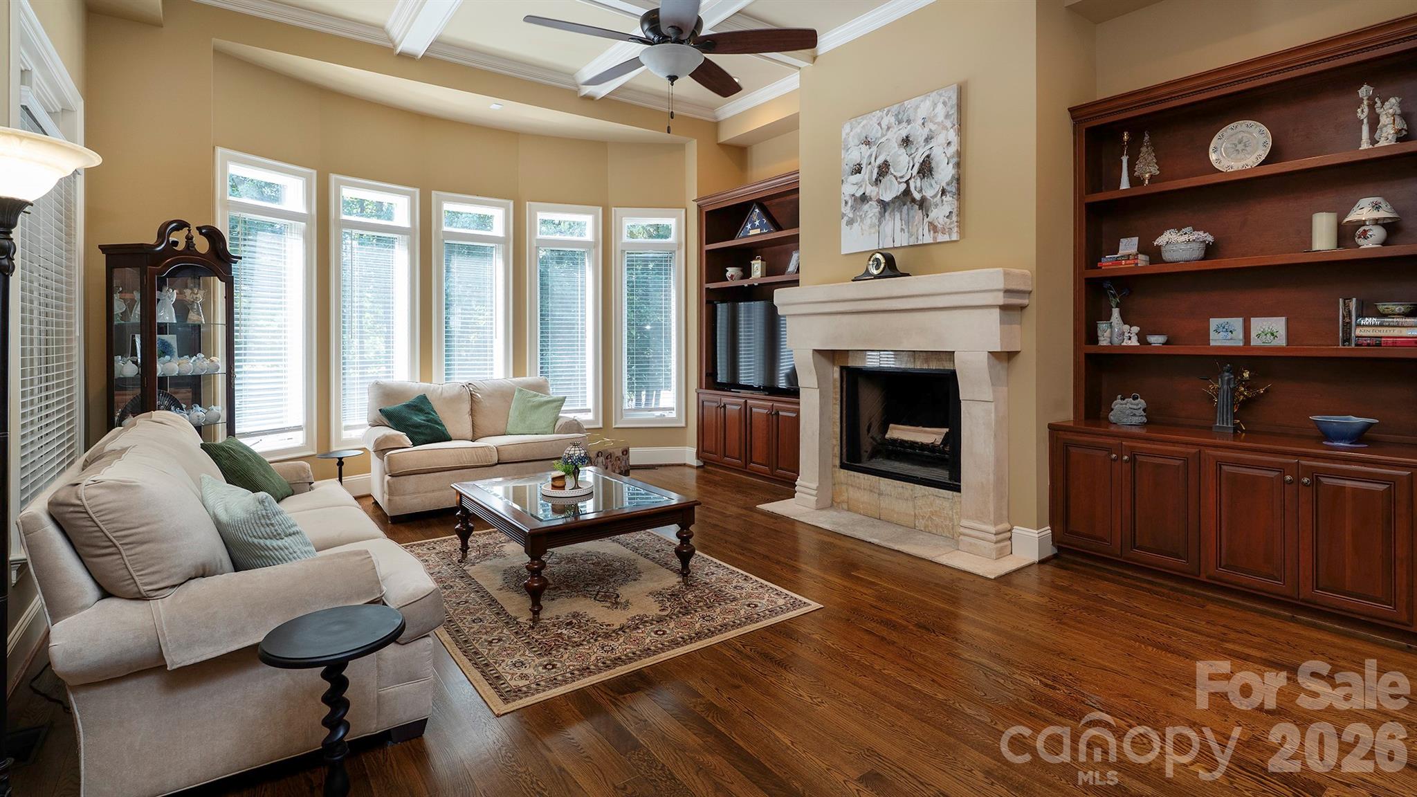Wood burning fireplace and custom book shelves... - 7786 Chapel Creek Drive, Denver