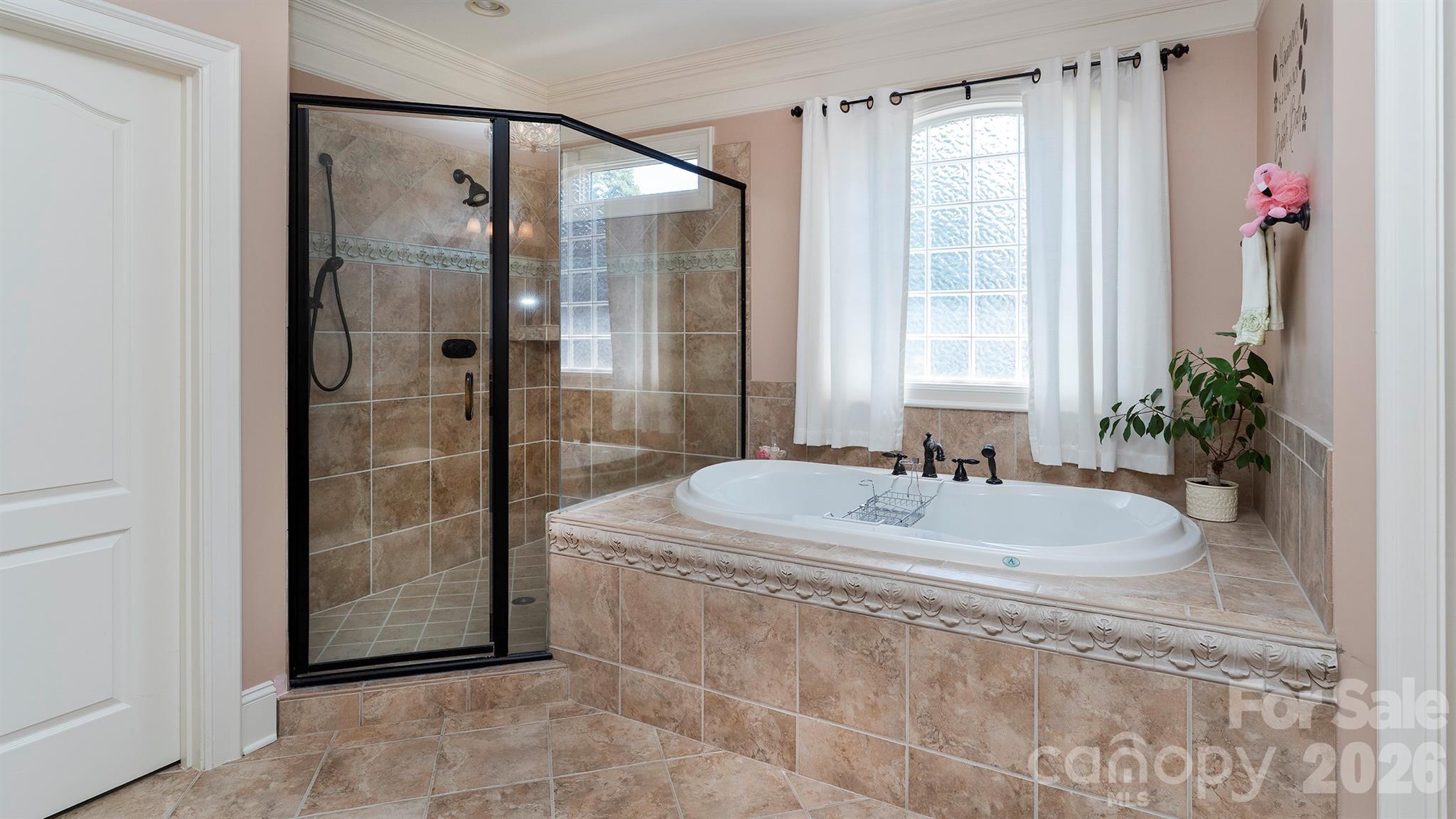 Primary bath soaking tub and shower... - 7786 Chapel Creek Drive, Denver