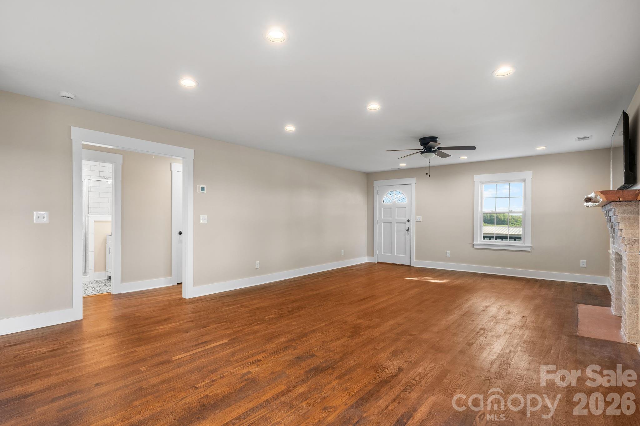 living area with view of the hallway to bedrooms - 1975 Three Forks Church Road, Taylorsville