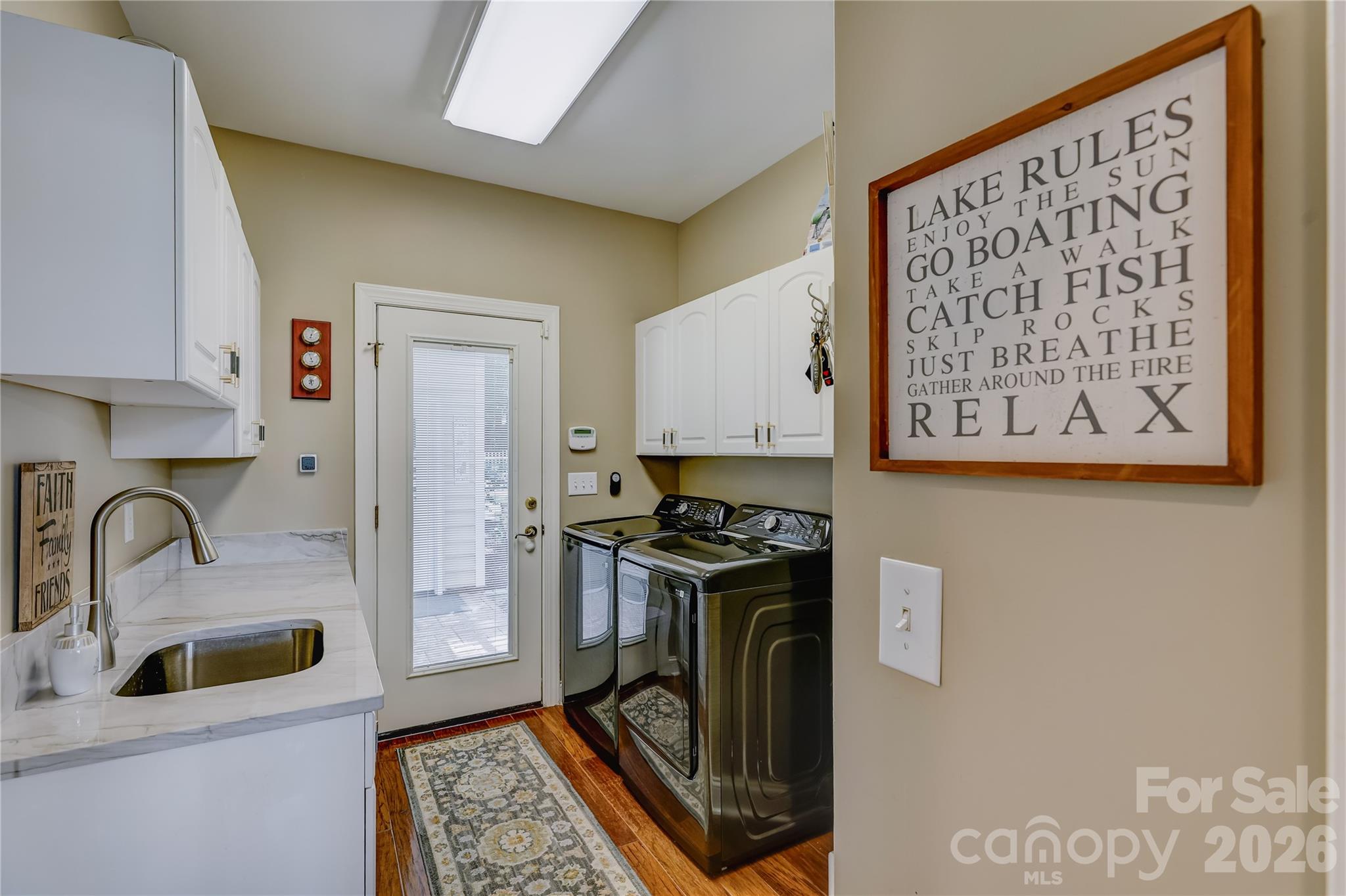 Large laundry room on the main level with direct access to the backyard. - 946 Lake Club Drive, Rock Hill