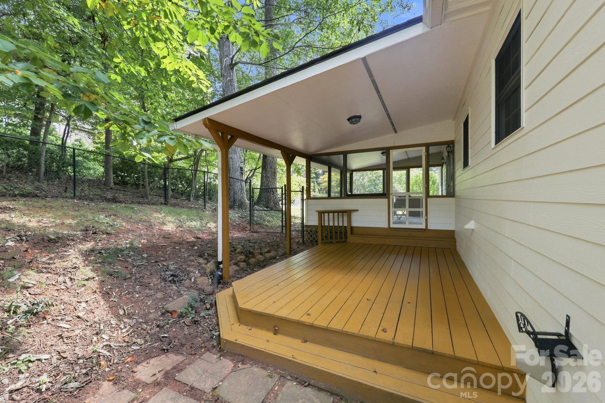 Covered back porch with fenced yard. - 95 Holly Ridge Road, Waynesville