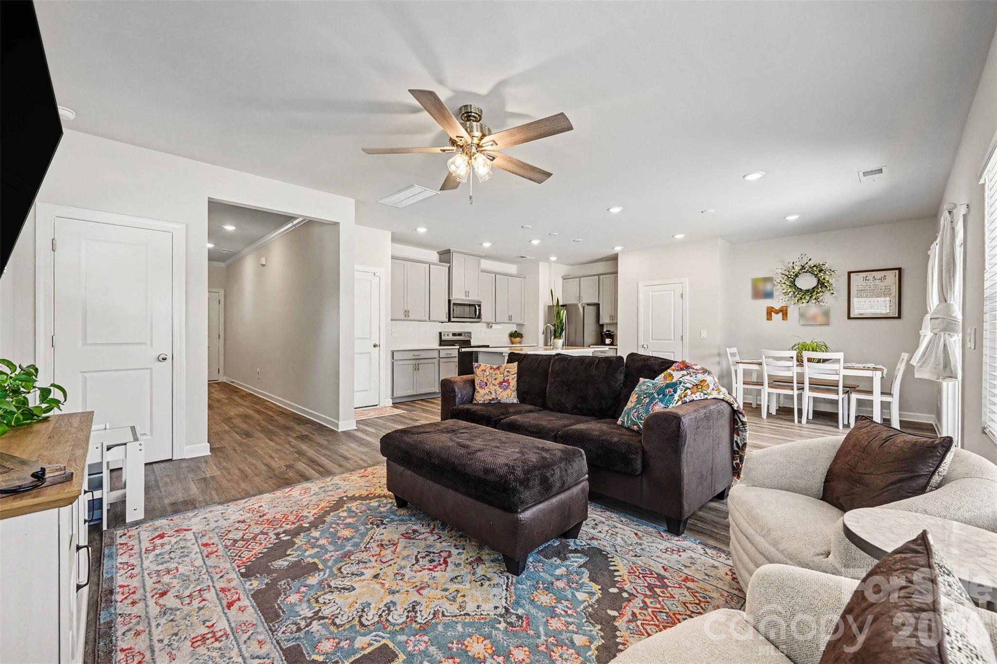 A hallway from the front door leads to an open living room, dining room, and kitchen. - 408 Luna Lane, Shelby