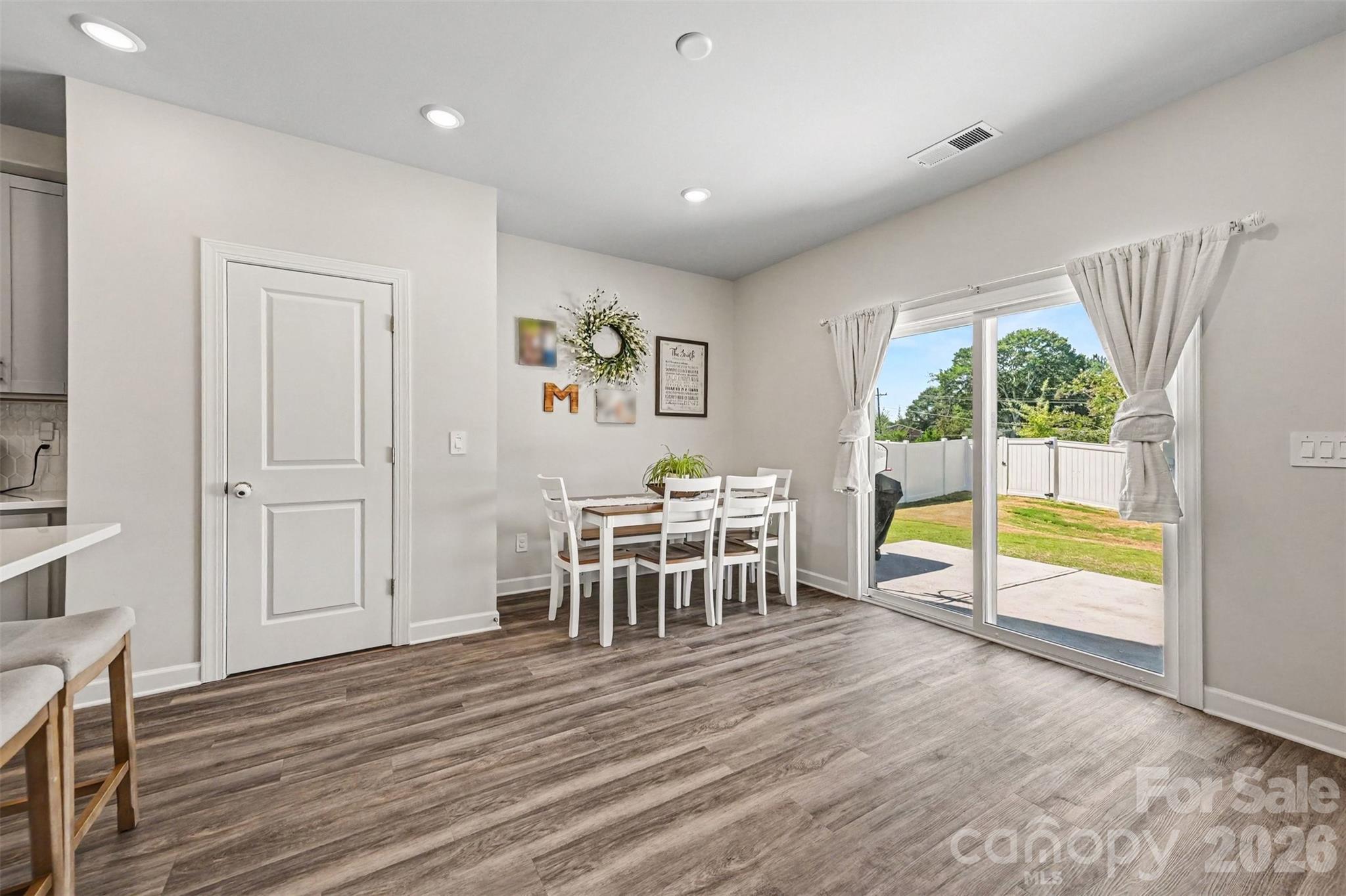 Here is the spacious dining area. The door on the left is a great pantry. The sliding doors lead to the back patio and yard. - 408 Luna Lane, Shelby