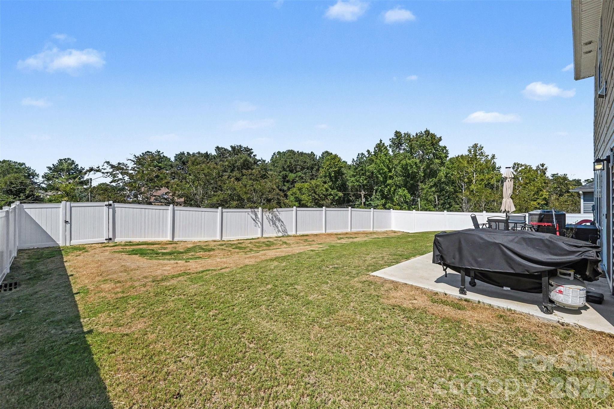 The back yard is fully fenced with a low maintenance vinyl fence! - 408 Luna Lane, Shelby
