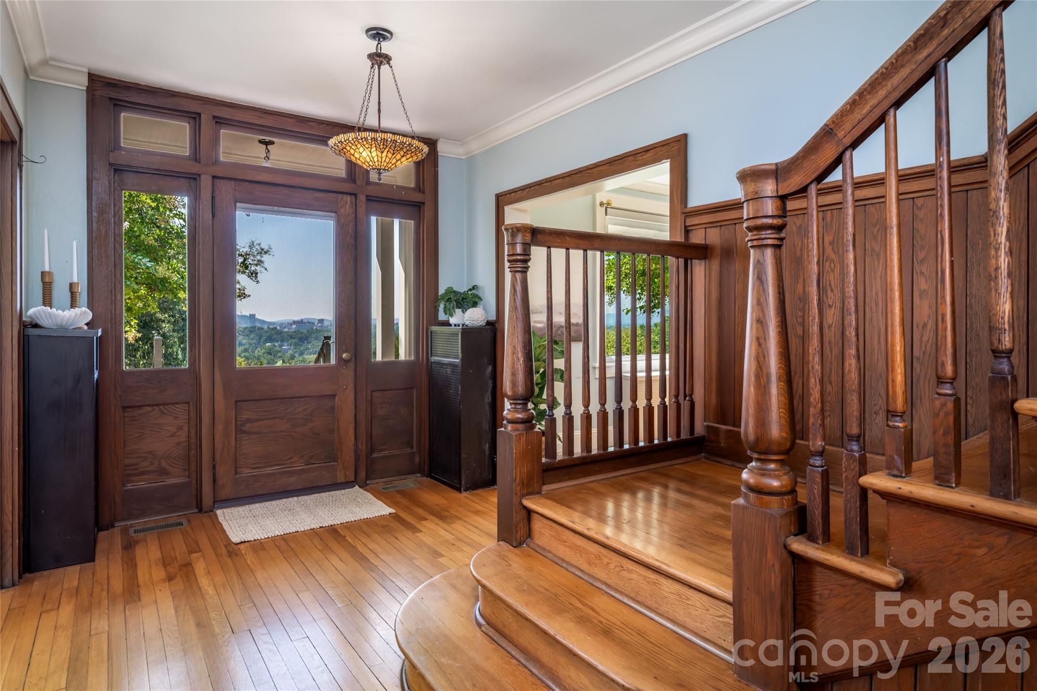 The front door and staircase showcase all the historic charm and craftman details - 35 Elias Place, Asheville