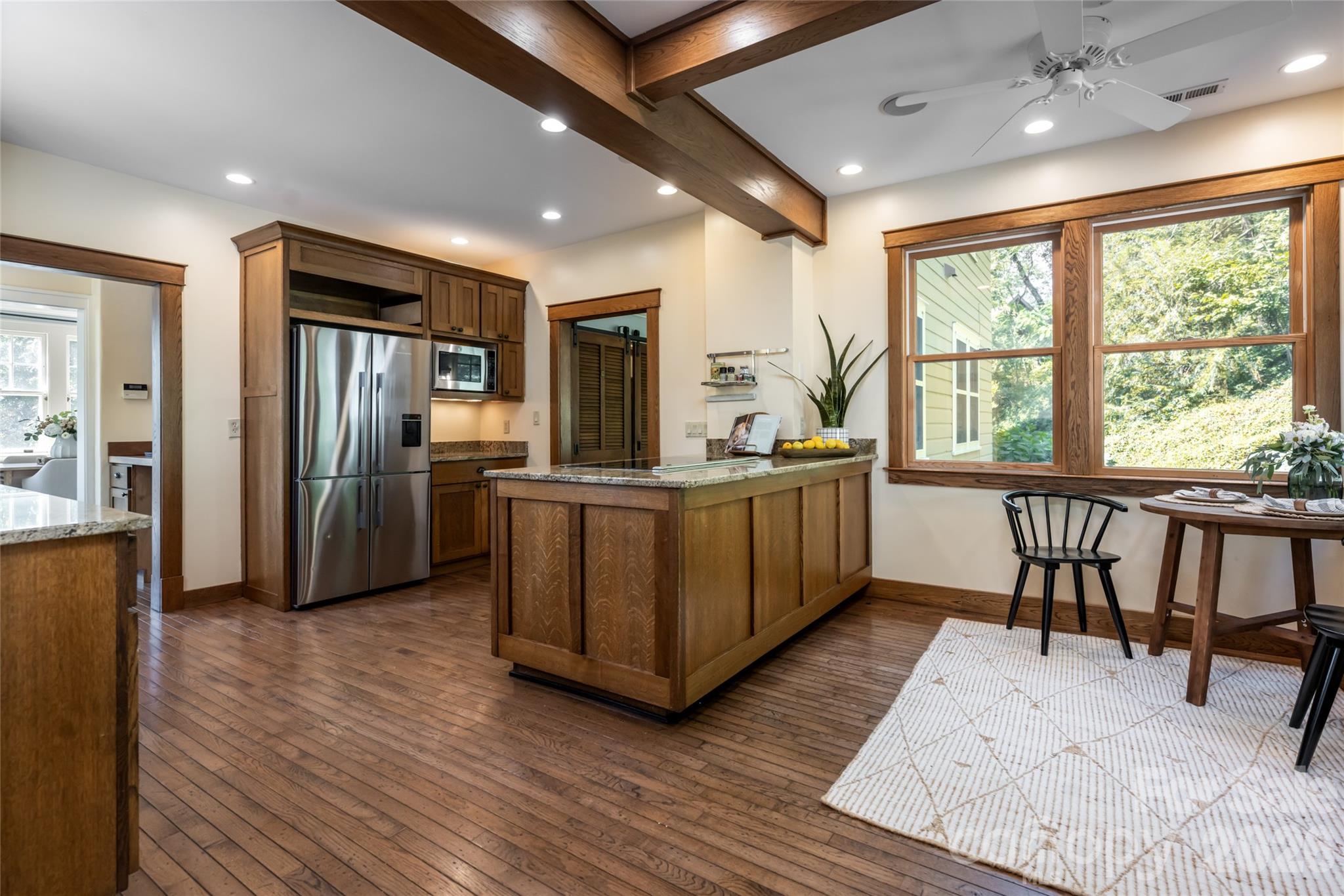 The kitchen features a breakfast nook, stunning wooden cabinets, updated appliances - 35 Elias Place, Asheville