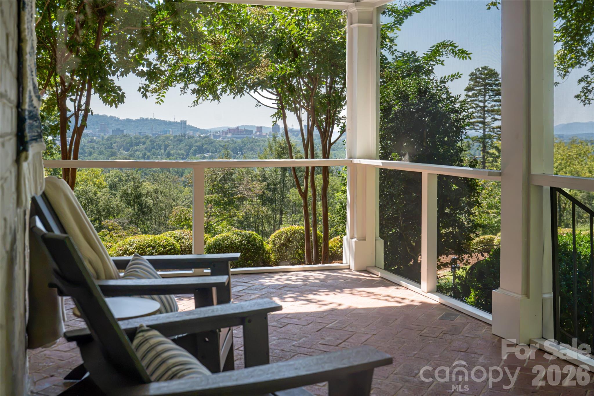 Enjoy coffee in the mornings as the sun rises over downtown or dinner alfresco on this screened in porch. - 35 Elias Place, Asheville