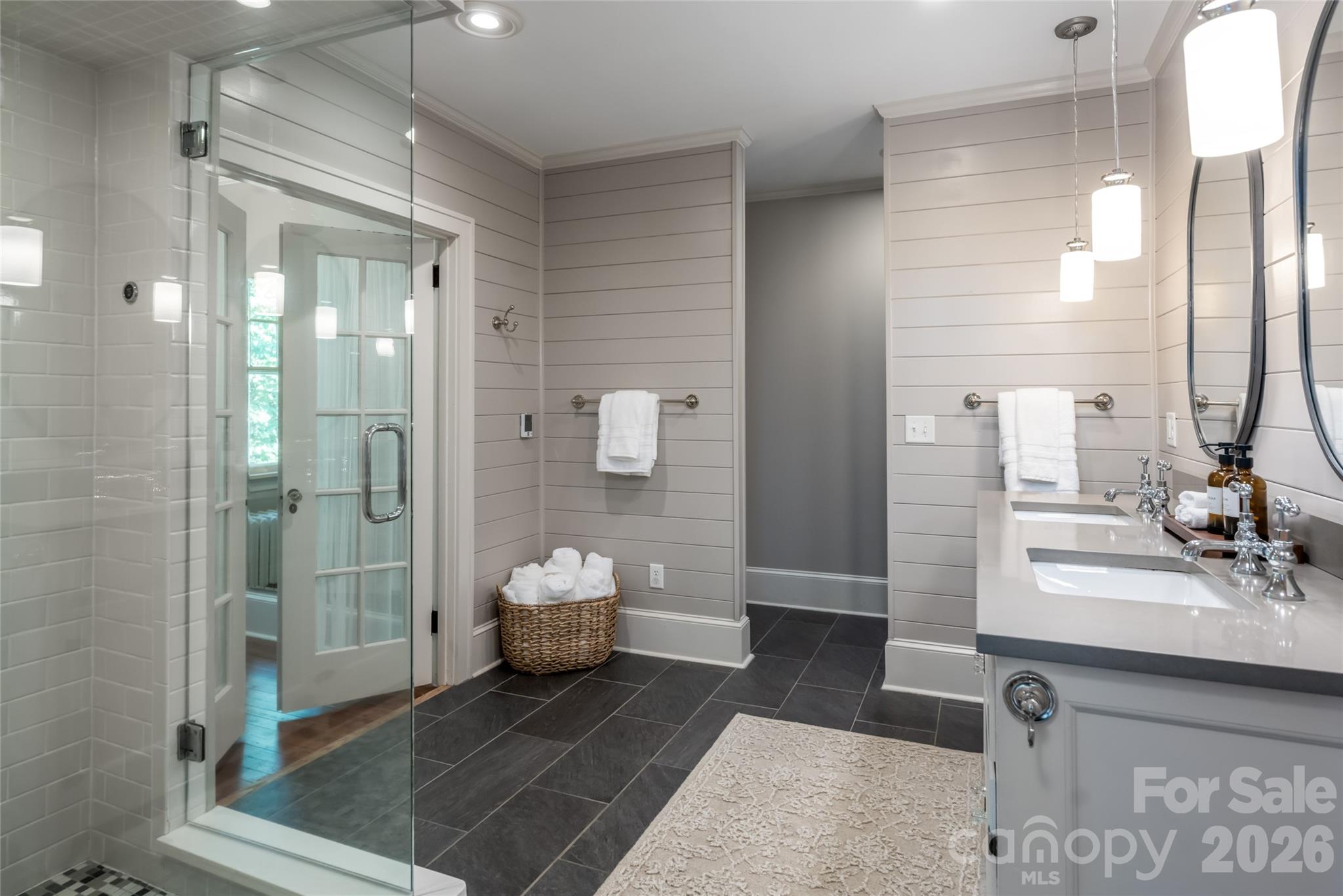 The primary bathroom gives ultimate spa vibes. with a steam shower and double vanity. - 35 Elias Place, Asheville